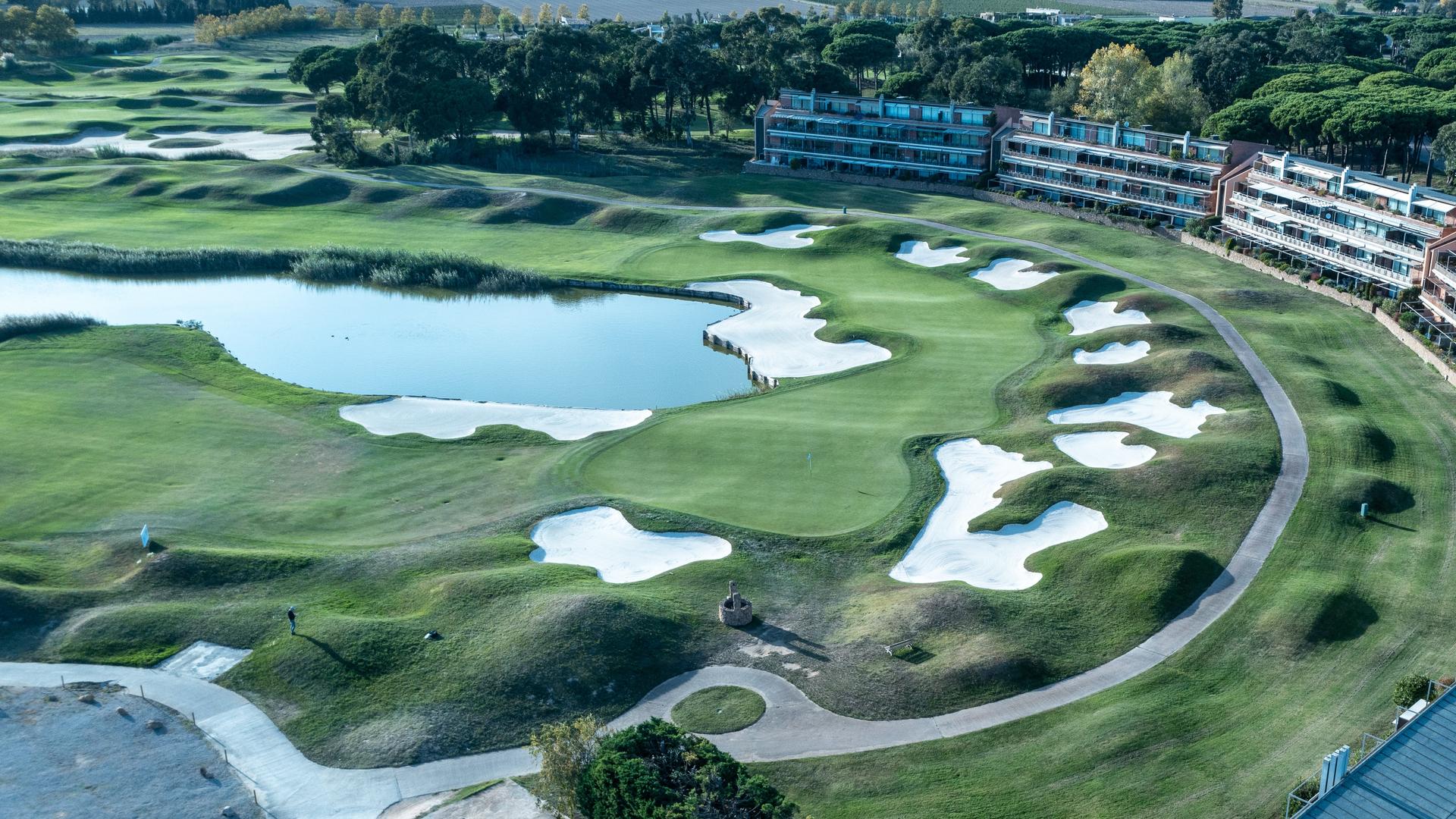 Overhead view of a well maintained fairway littered with sand bunkers