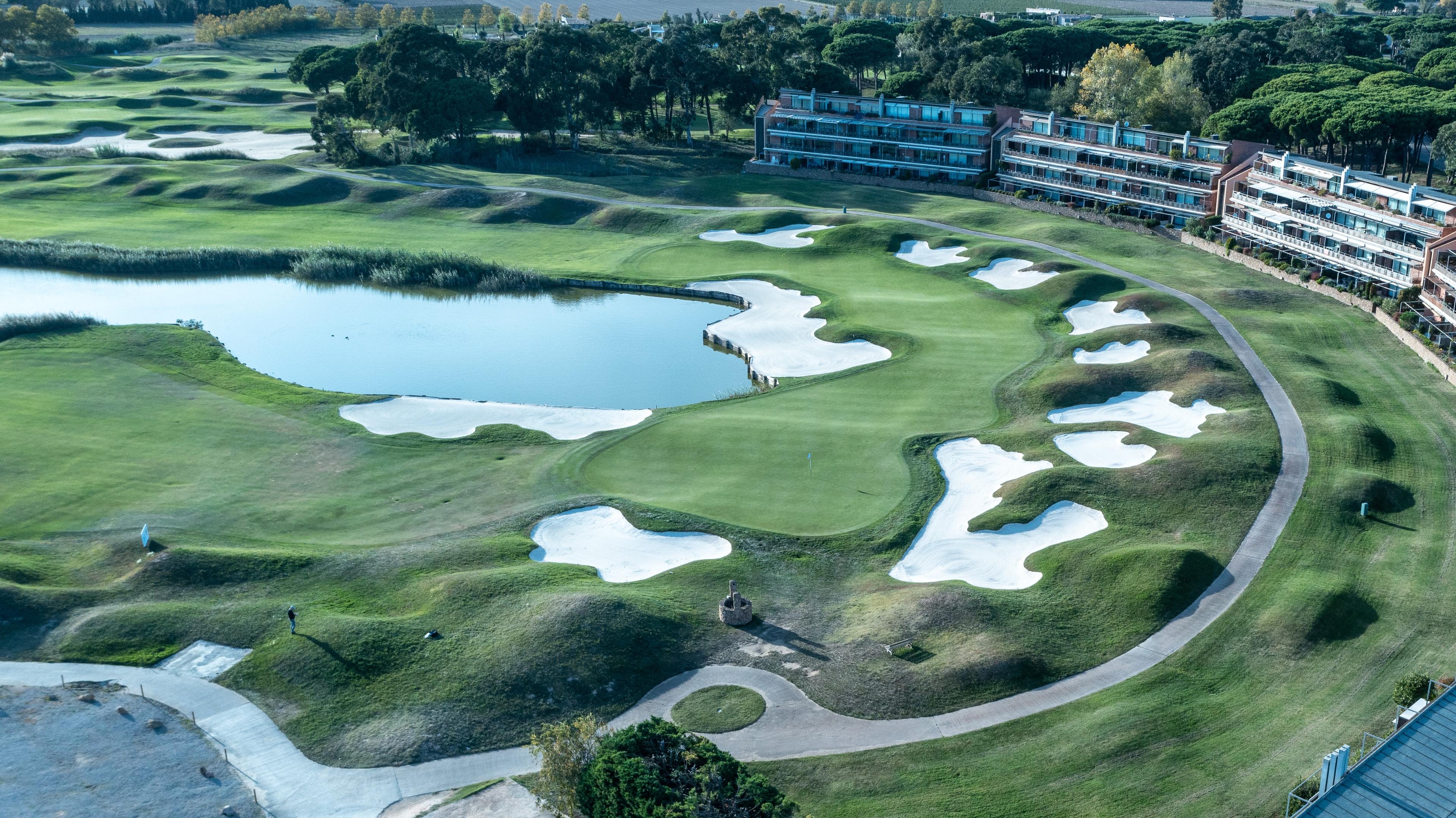Overhead view of a well maintained fairway littered with sand bunkers