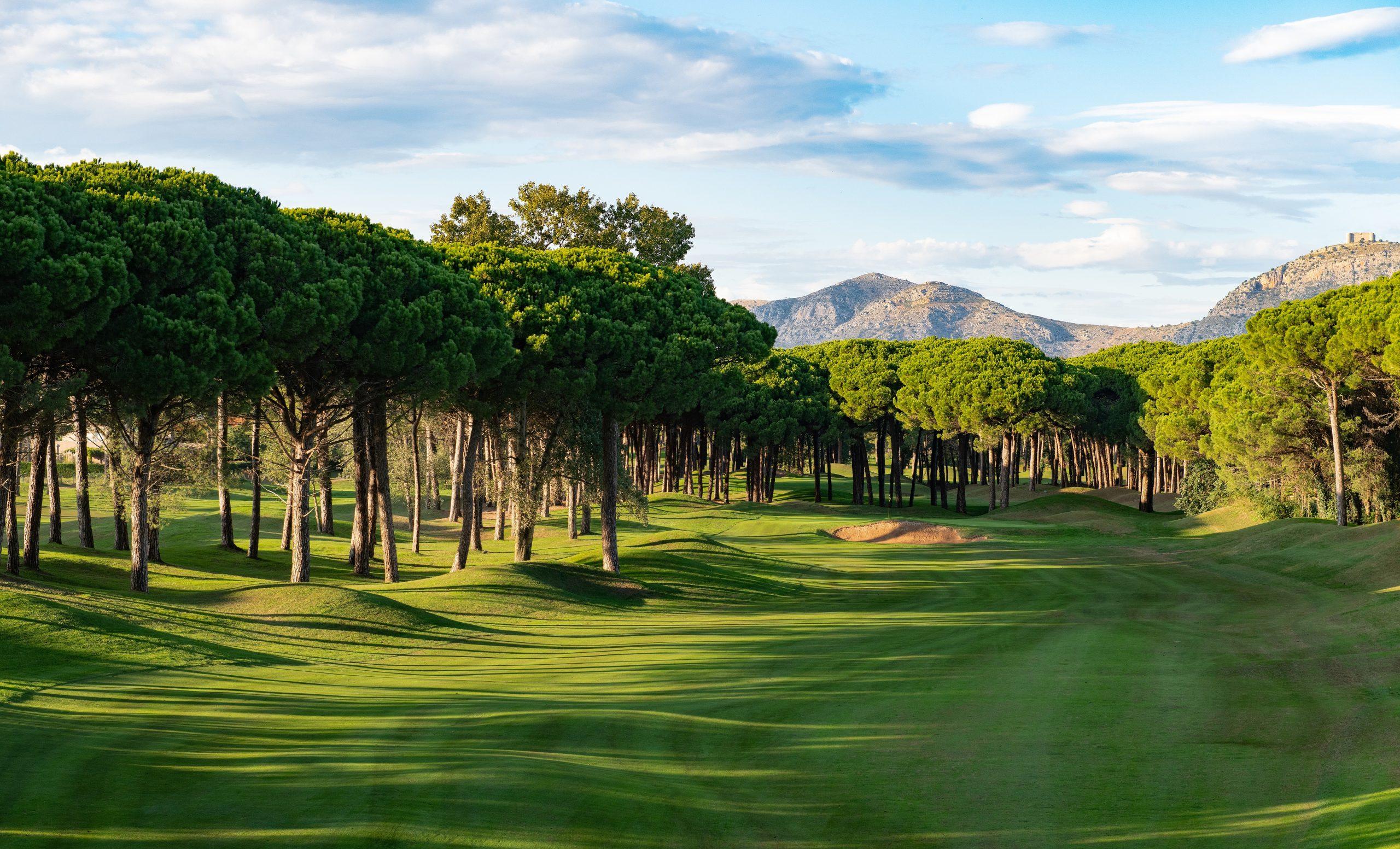 A well maintained fairway with mountain views in the distance