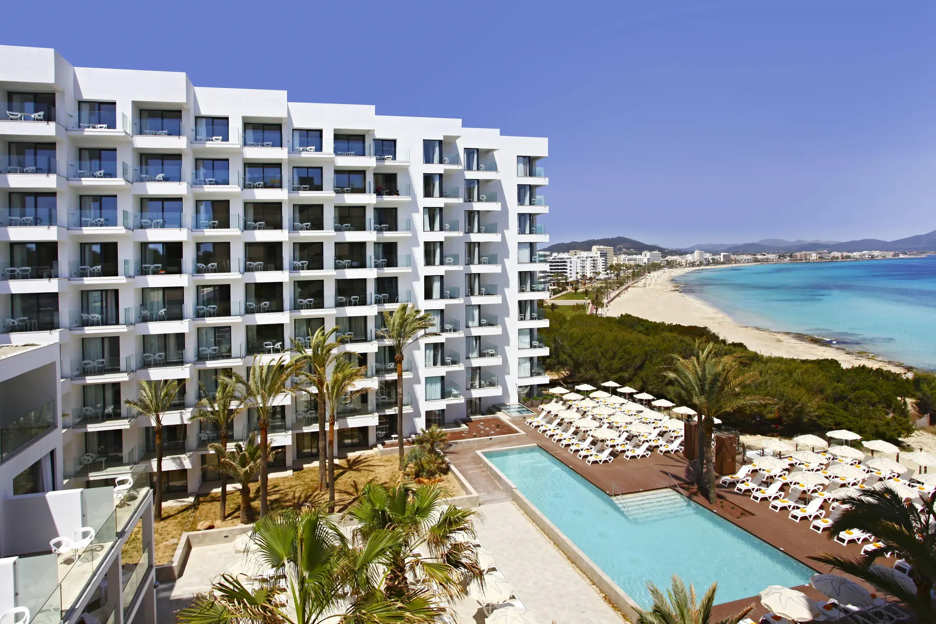 The Iberostar Waves Cala Millor building overlooking the outdoor pool with beach views
