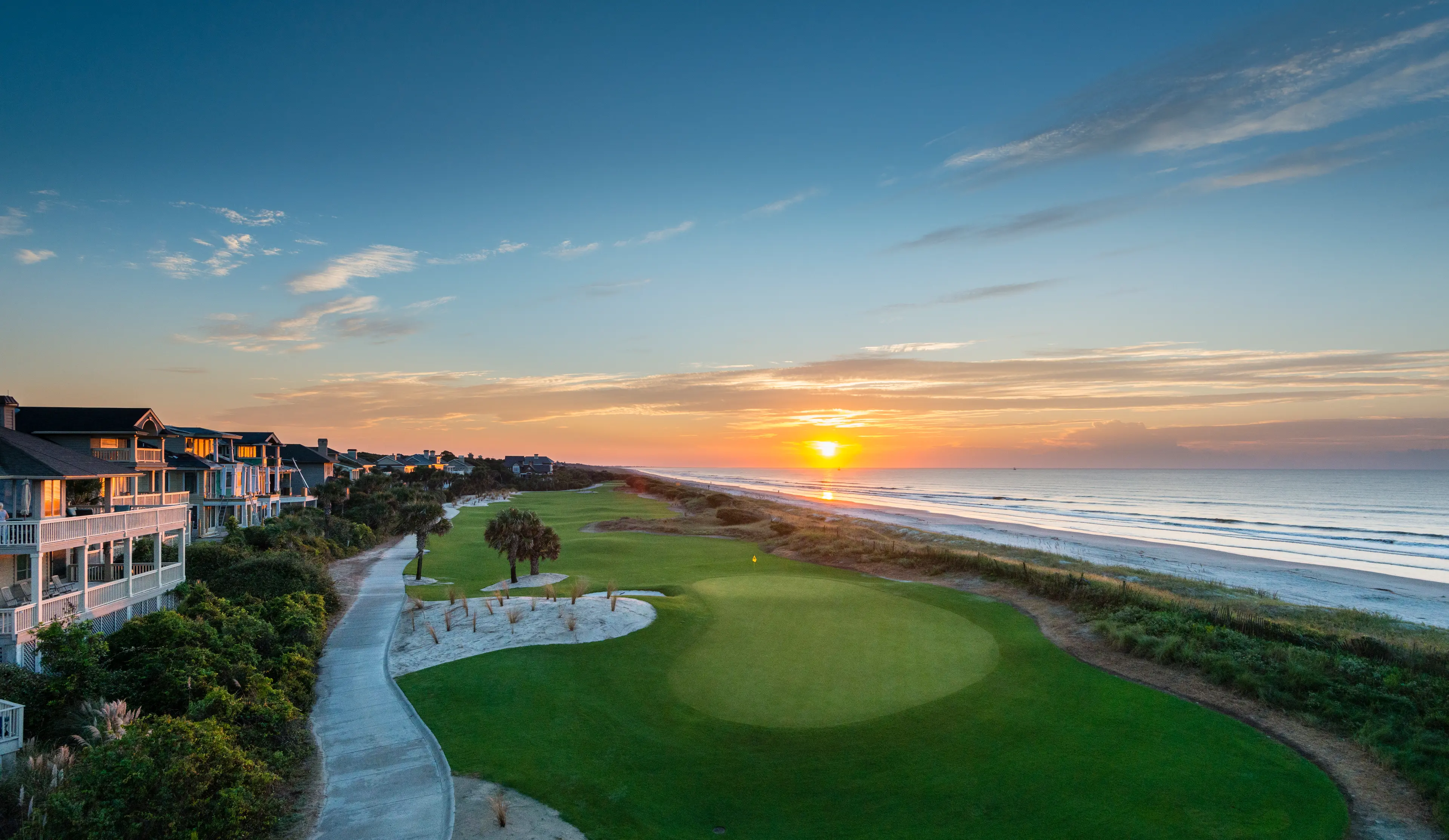 Panoramic view of the sun setting over a coastal fairway at Kiawah Island Golf Resort
