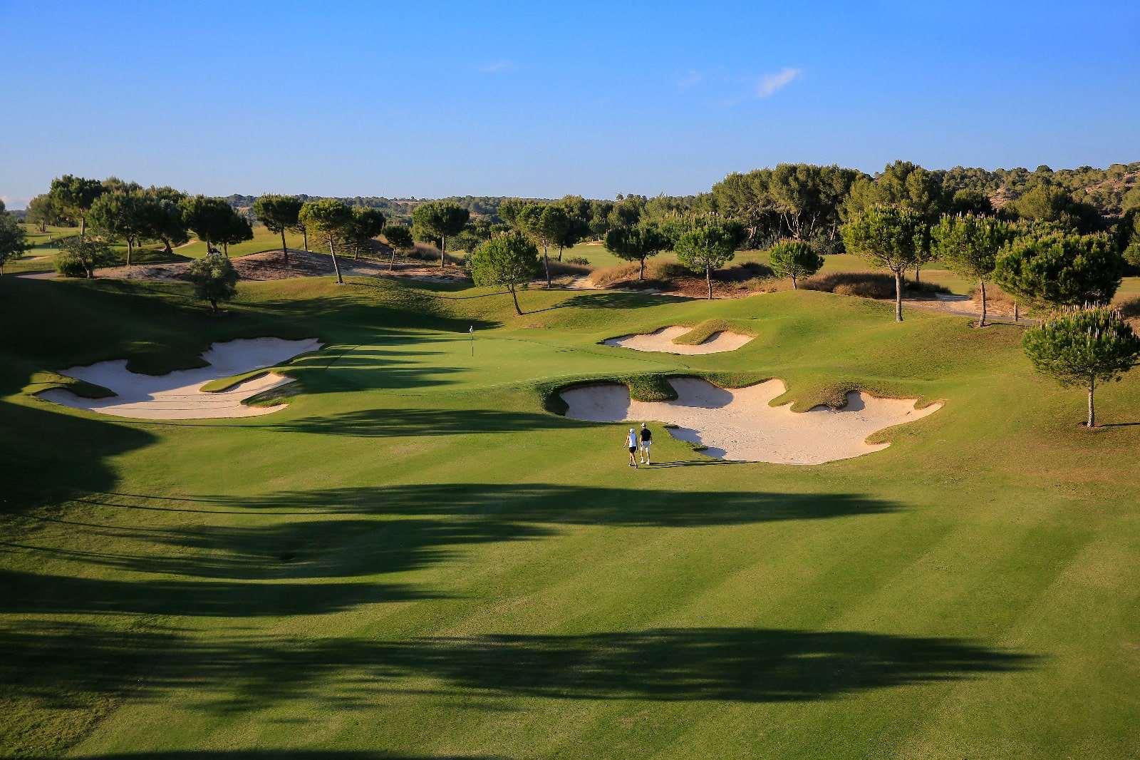 A well maintained fairway nestled with sand bunkers at Las Colinas Residences