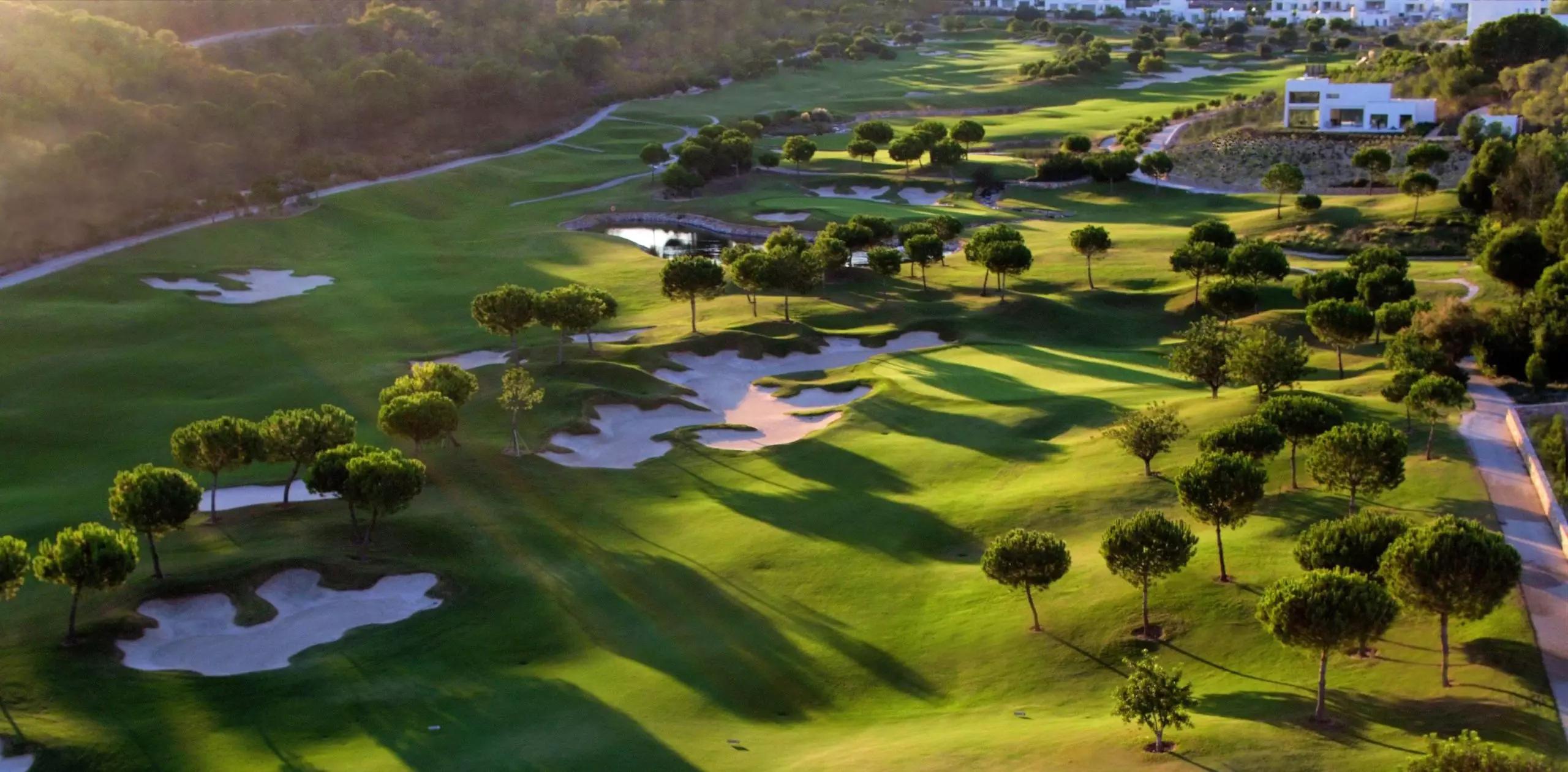 A well maintained fairway nestled with sand bunkers