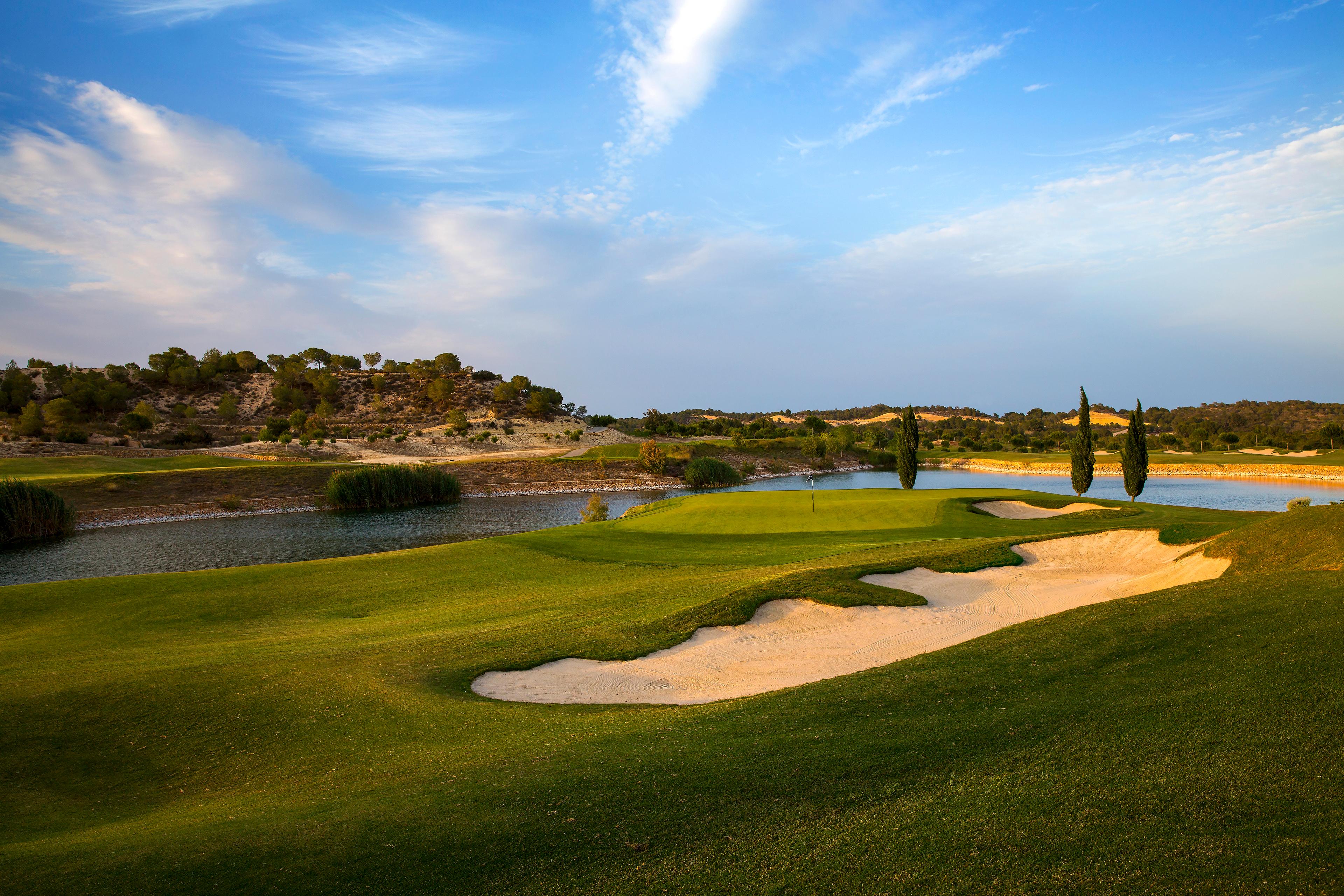 A well maintained fairway nestled with a sand bunker at Las Colinas Residences