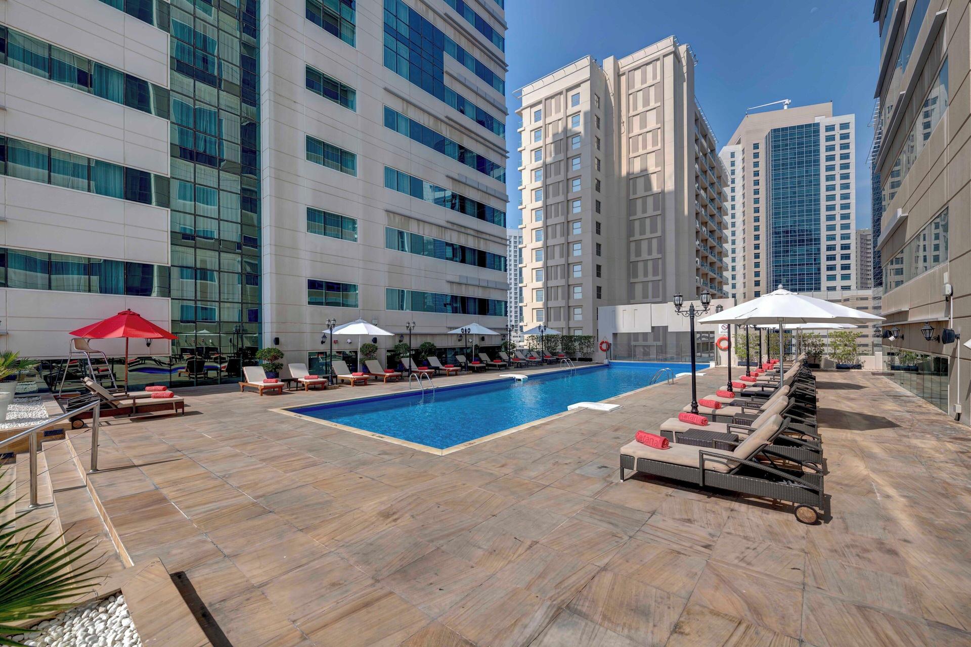 Panoramic view of the outdoor swimming pool at Media Rotana Dubai