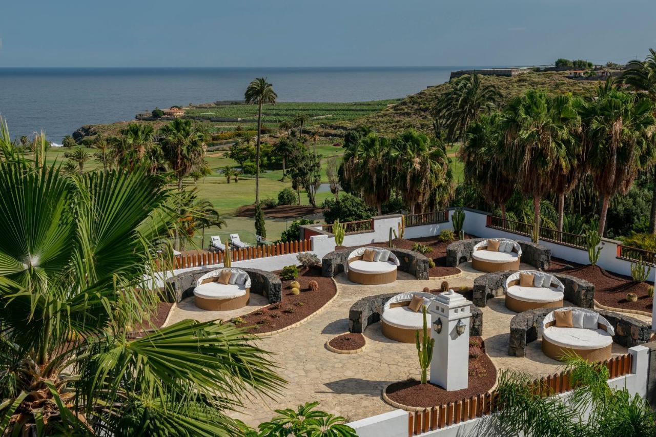 Outdoor lounging area with views of the coast at Melia Hacienda Del Conde