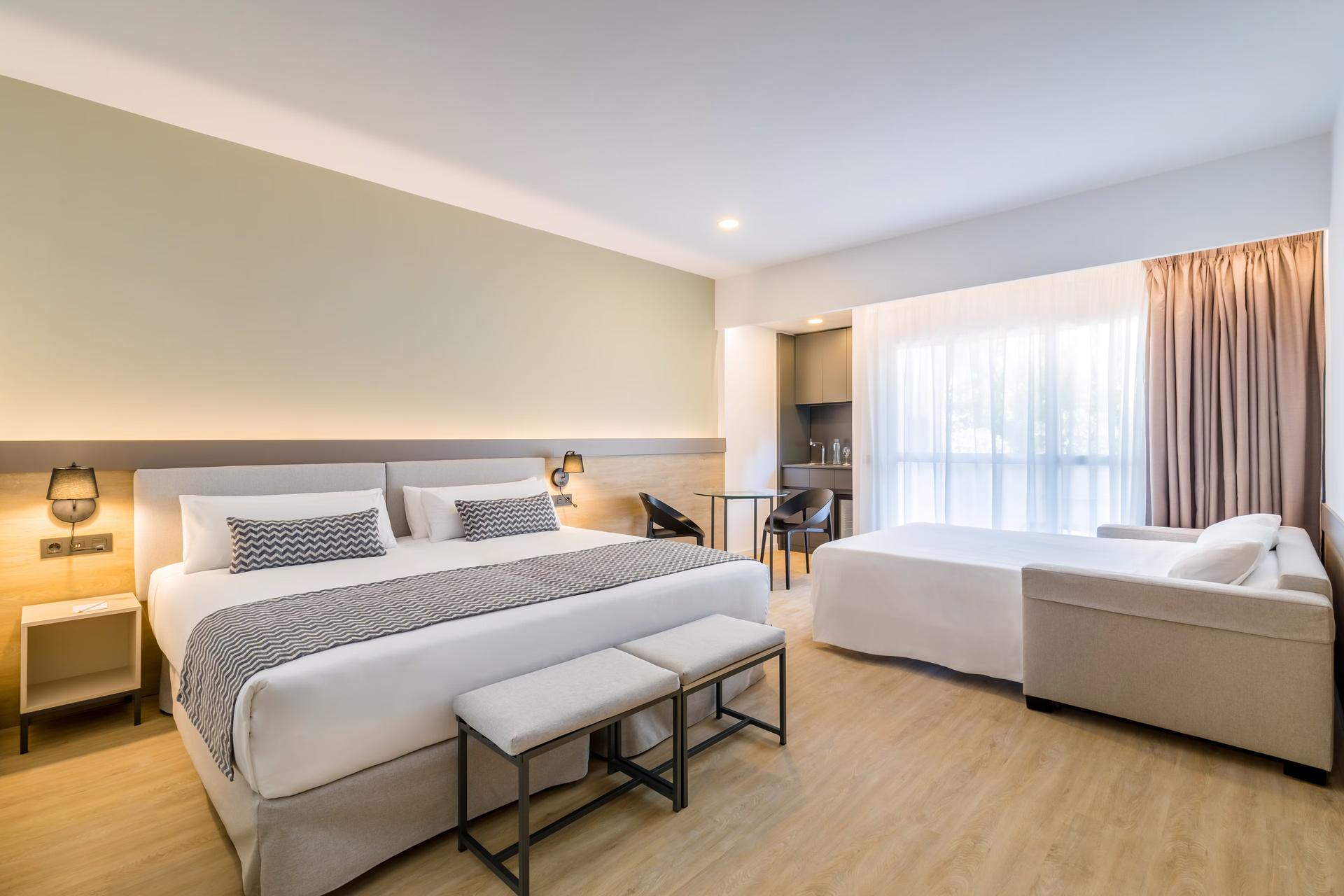 Spacious double bed room at Occidental Puerto Banus with a sofa bed