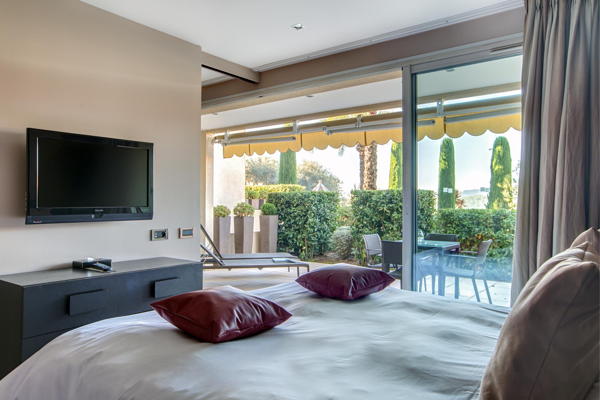 Double bed suite with a patio space at Royal Mougins Golf & Resort