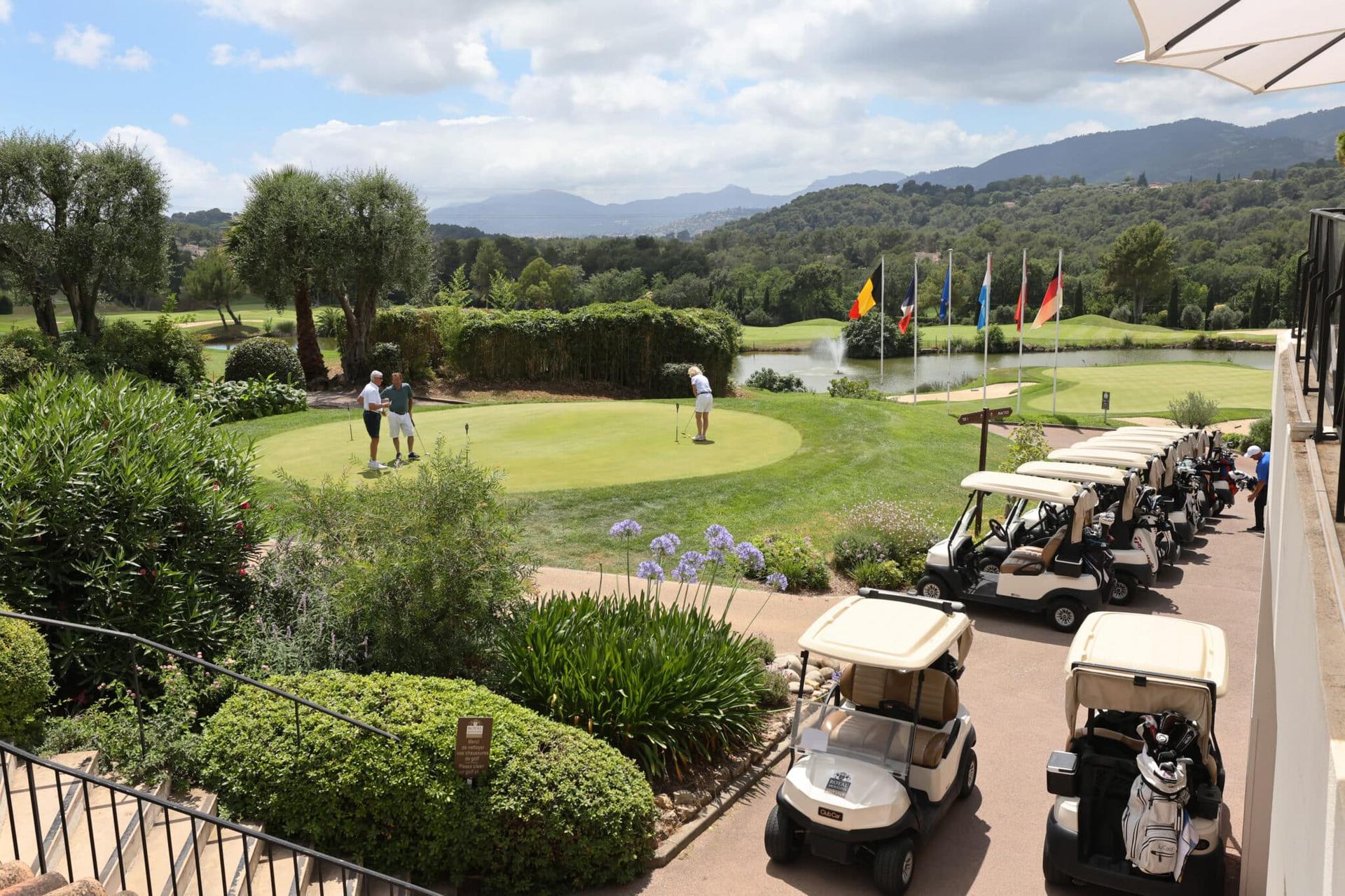 Overhead view of buggies parked up next to a practice green