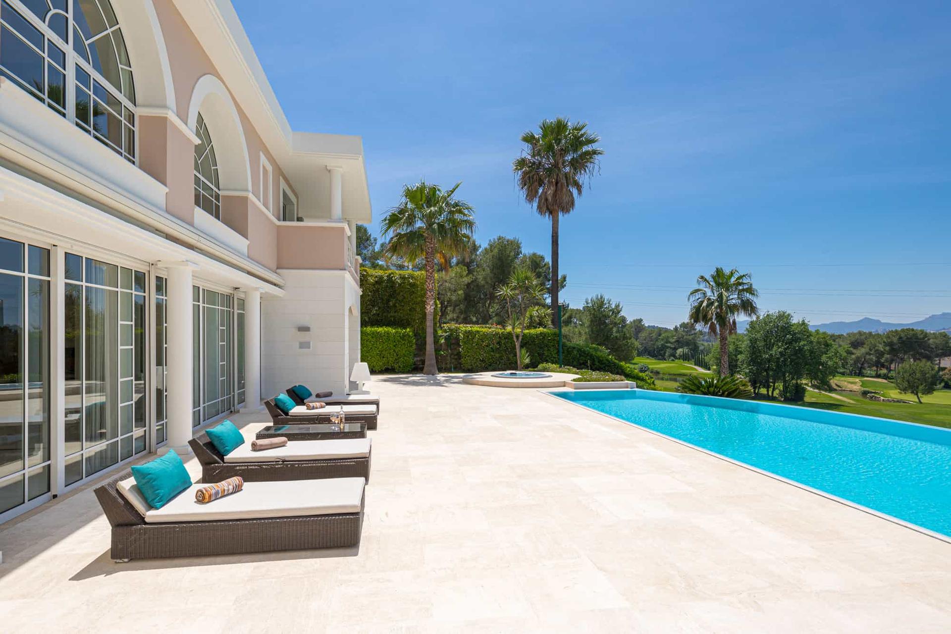 Outdoor swimming pool lined with sunbeds at Royal Mougins Golf & Resort