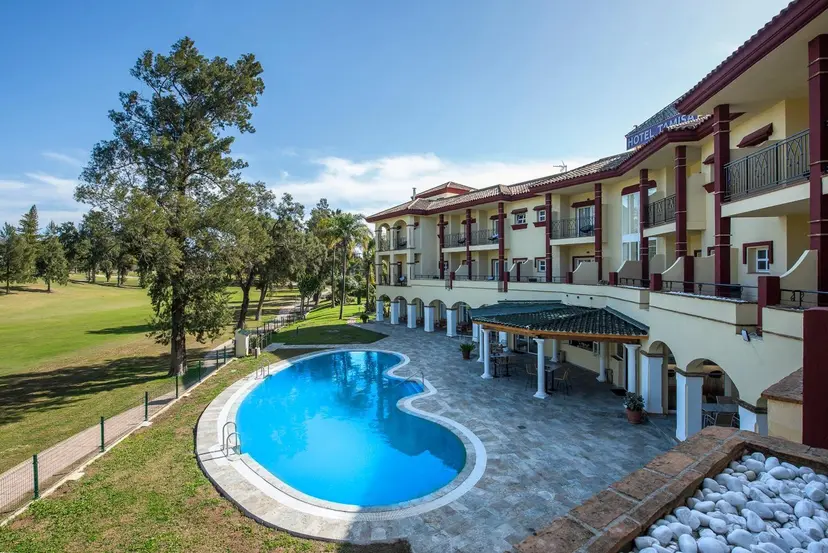 Panoramic view of the outdoor swimming pool with views of the course at Tamisa Golf Hotel