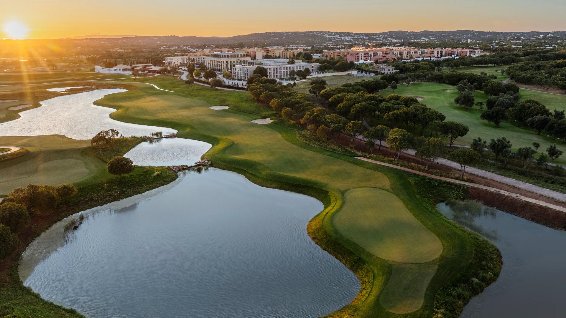 Overhead view of the sun setting over the The Els Club Vilamoura golf course