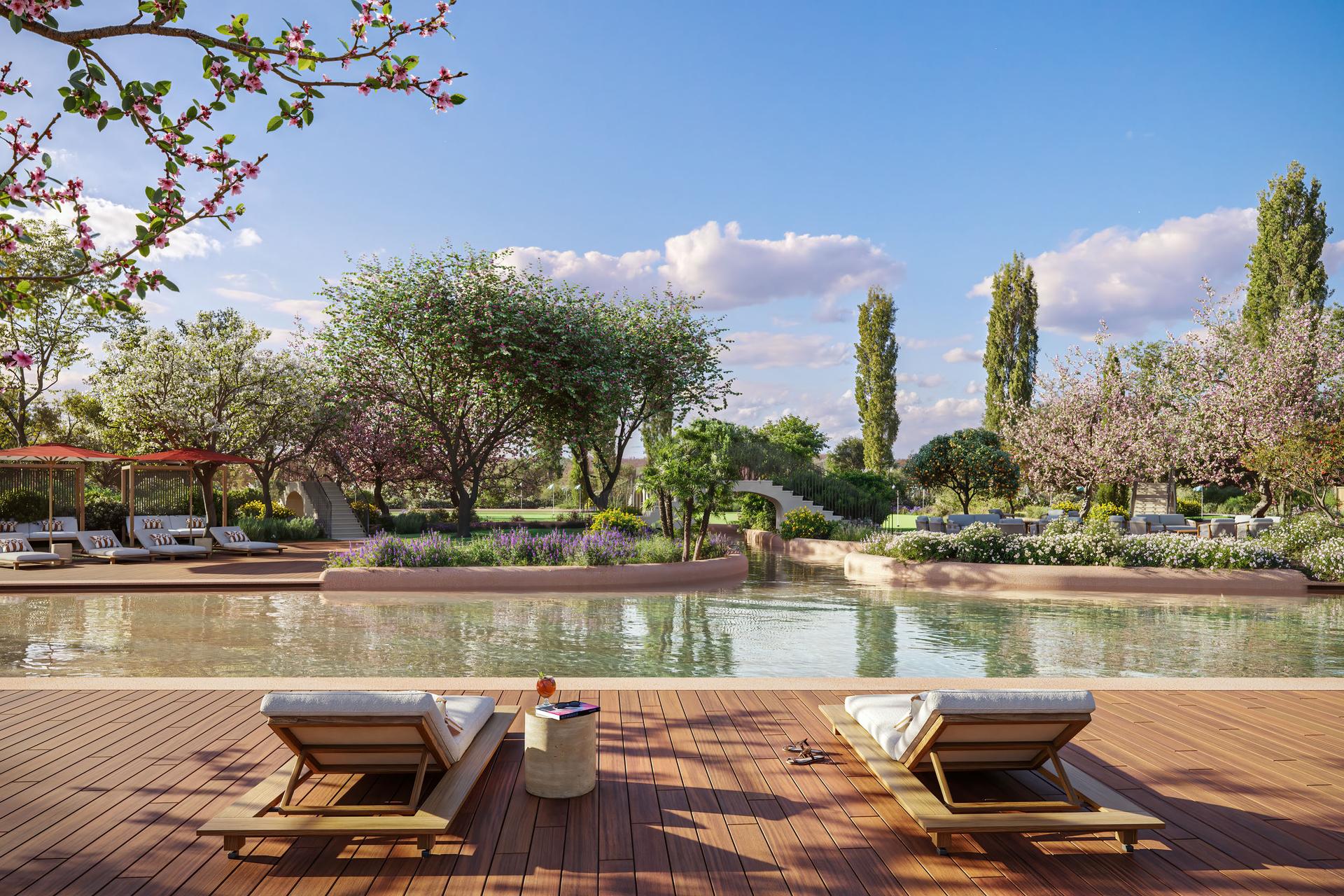 Outdoor pool lined with sunbeds at The Els Club Vilamoura