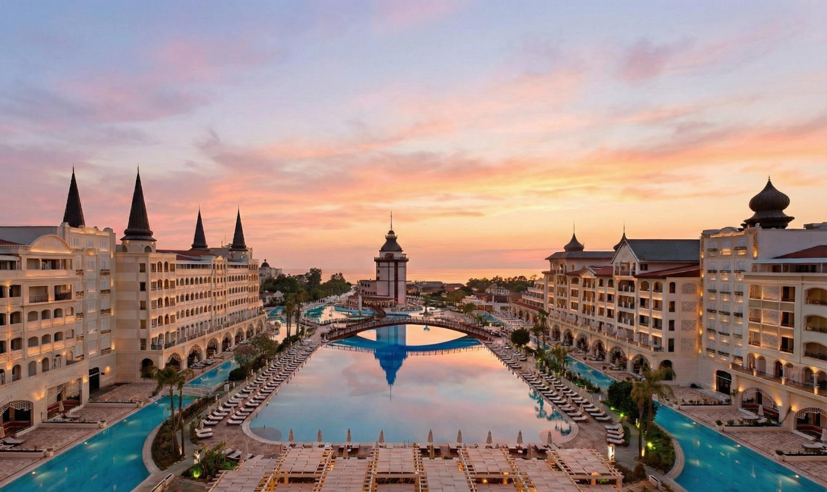 Sun setting over the outdoor pool at Titanic Mardan Palace