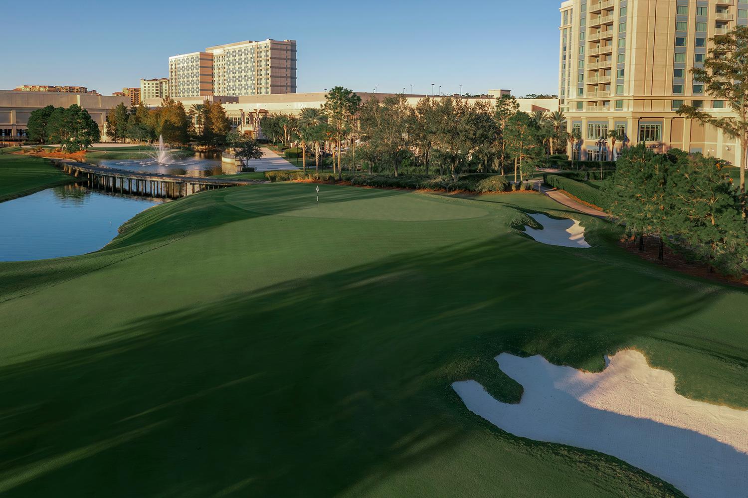 Panoramic view of a well maintained fairway nestled with sand bunkers leading to a smooth green