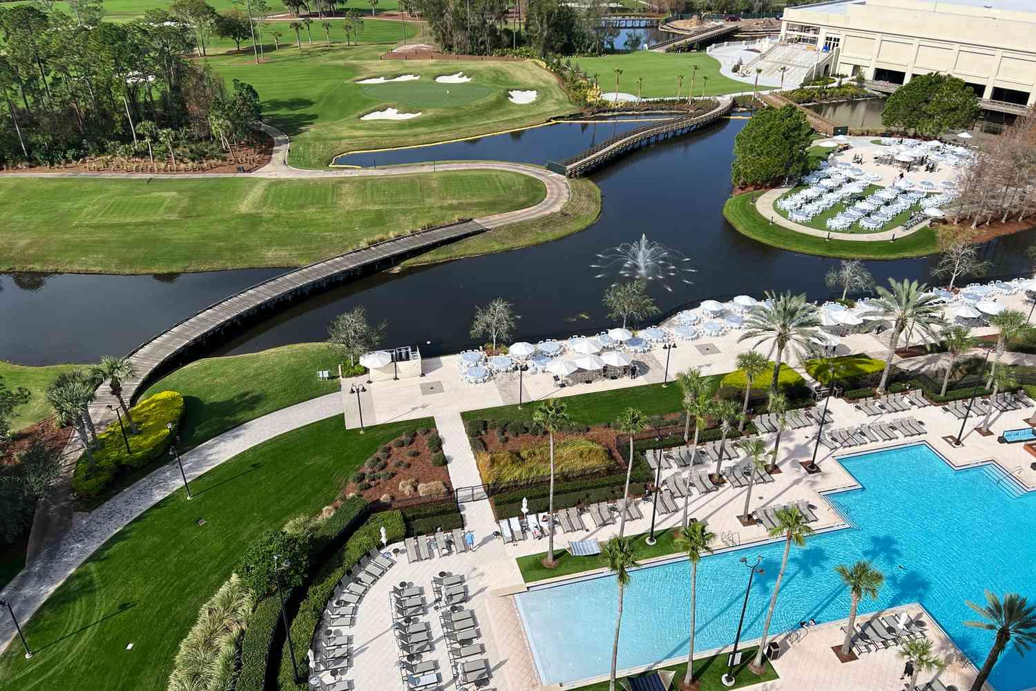 Aerial view of the outdoor swimming pool at Waldorf Astoria with views of the golf course