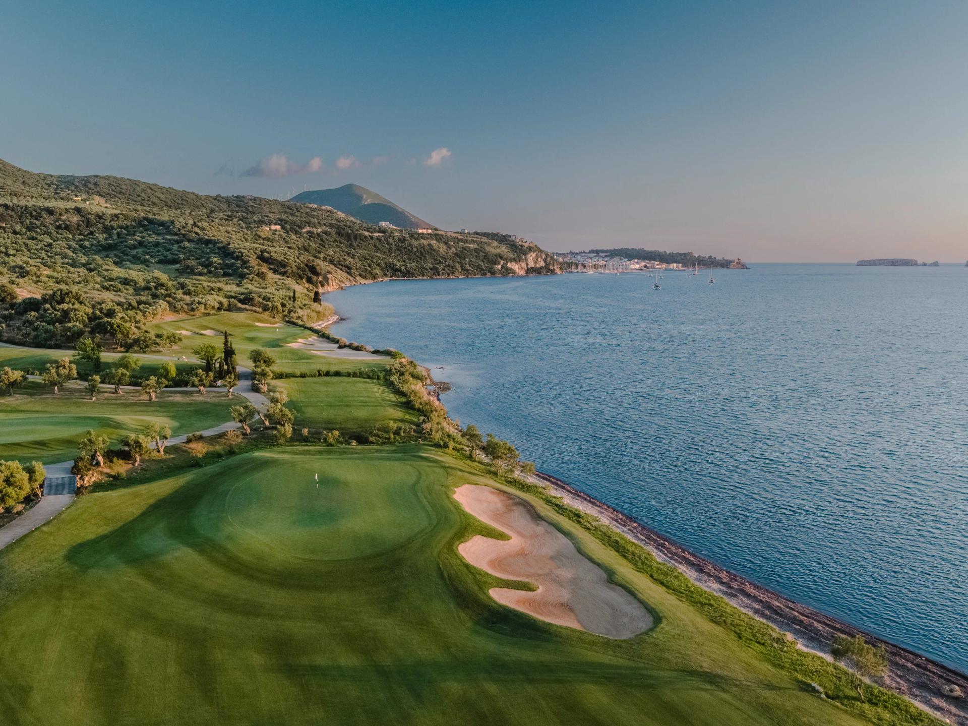 Overhead view of a smooth coastal green next to a large sand bunker