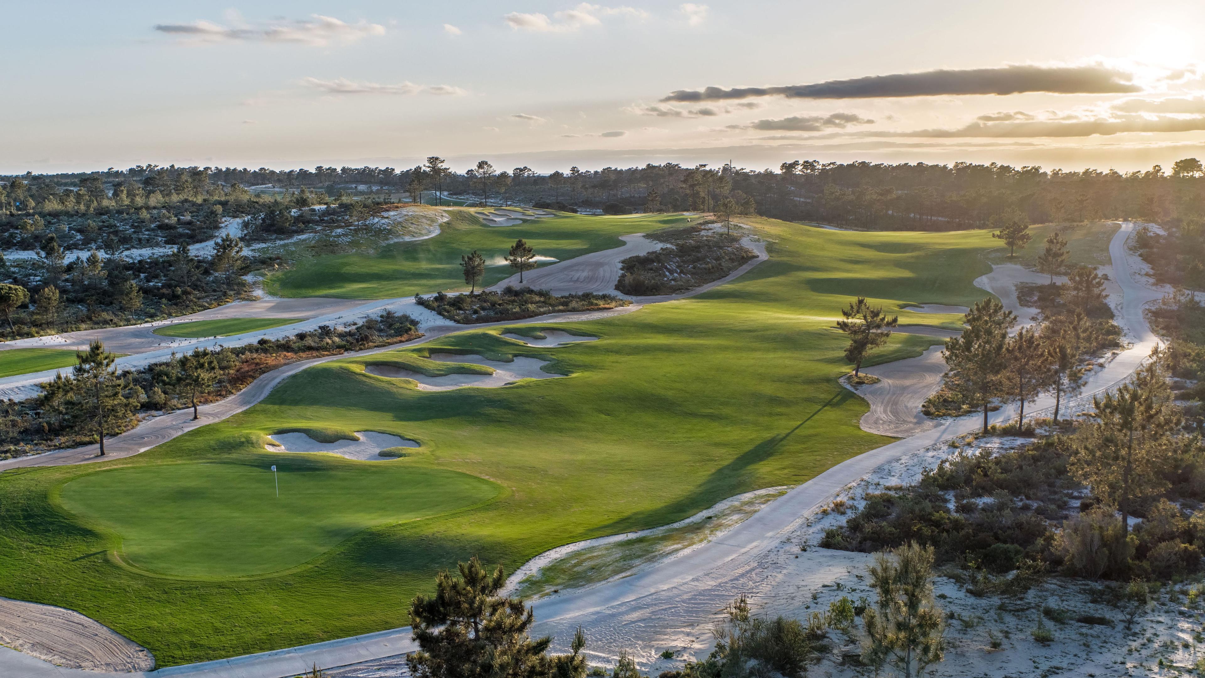 A well maintained fairway at sun set leading to a smooth green