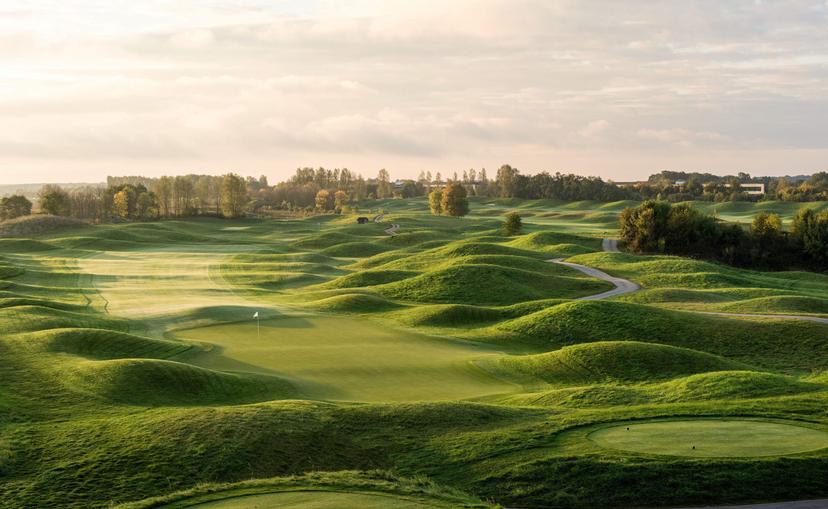 A well maintained fairway surrounded by rolling dunes