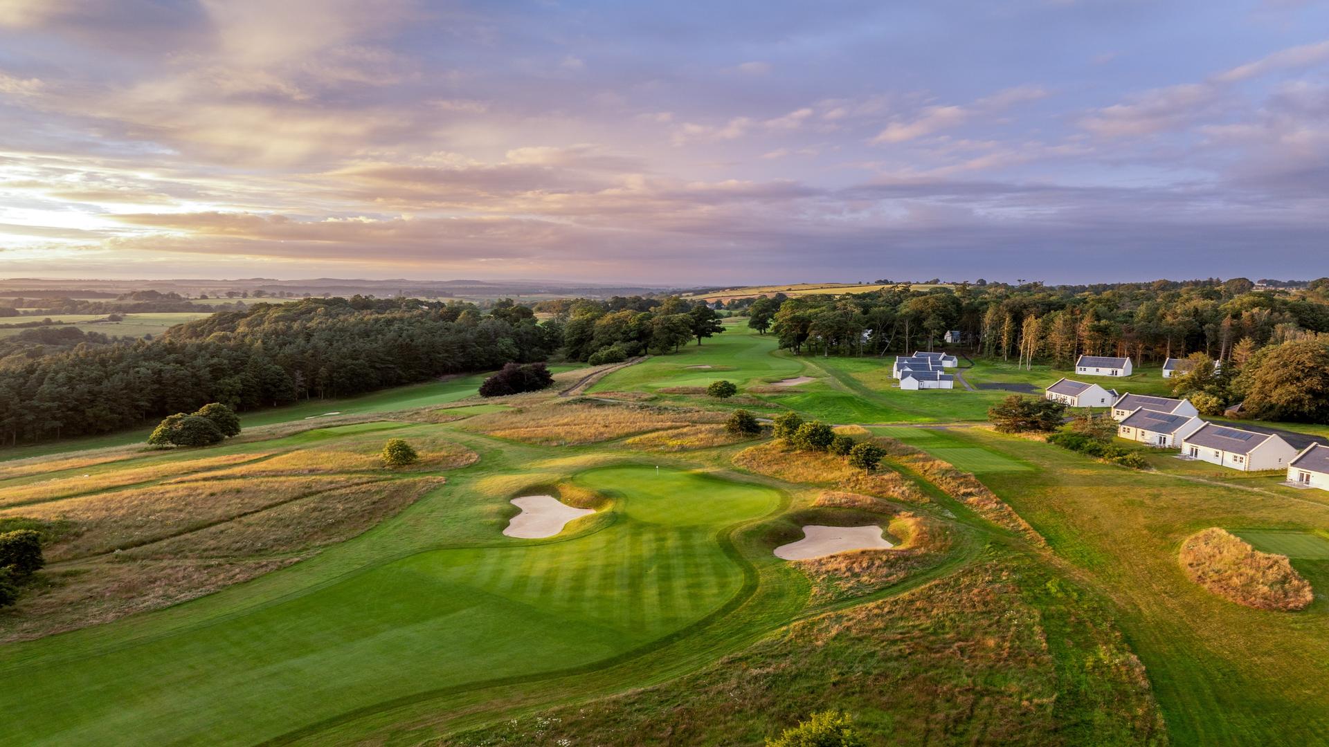 A well maintained fairway leading to a smooth green surrounded by sand bunkers