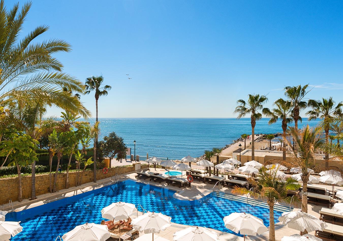 Overhead view of the outdoor swimming pool with coastal views at Amàre Beach Hotel Marbella