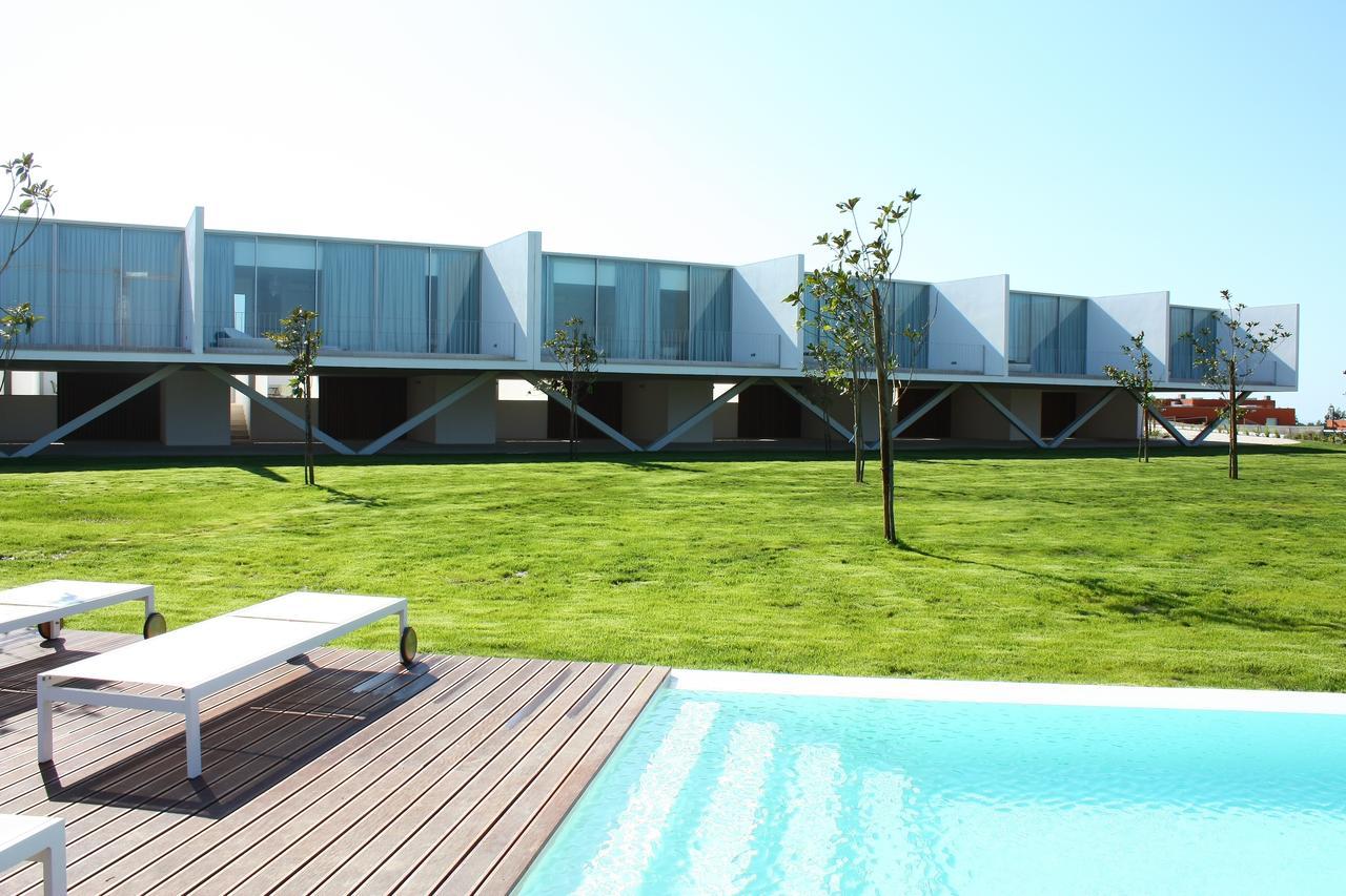Villas overlooking an outdoor swimming pool at Bom Sucesso Resort