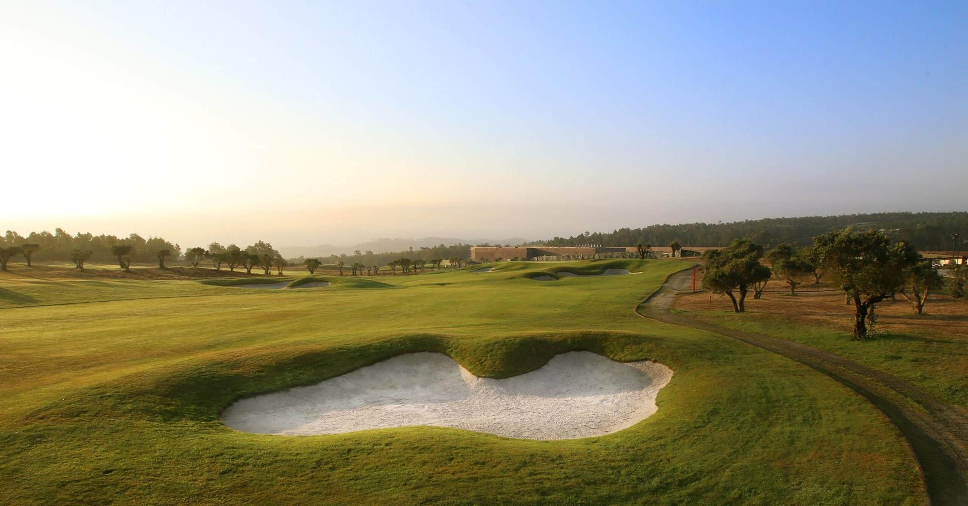 A well maintained fairway nestled with a large sand bunker at Bom Sucesso Resort