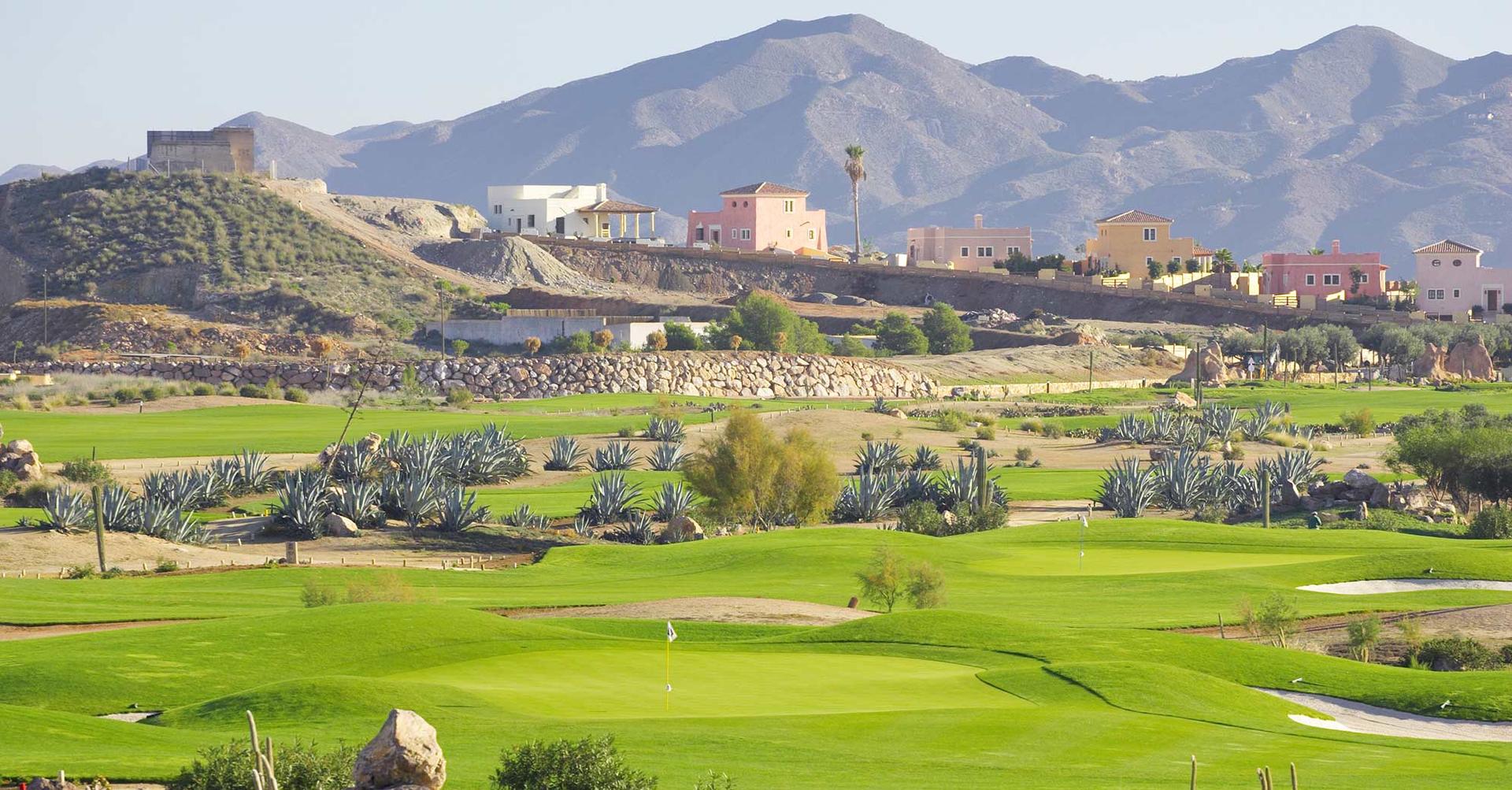 A well maintained fairway nestled with sand bunkers