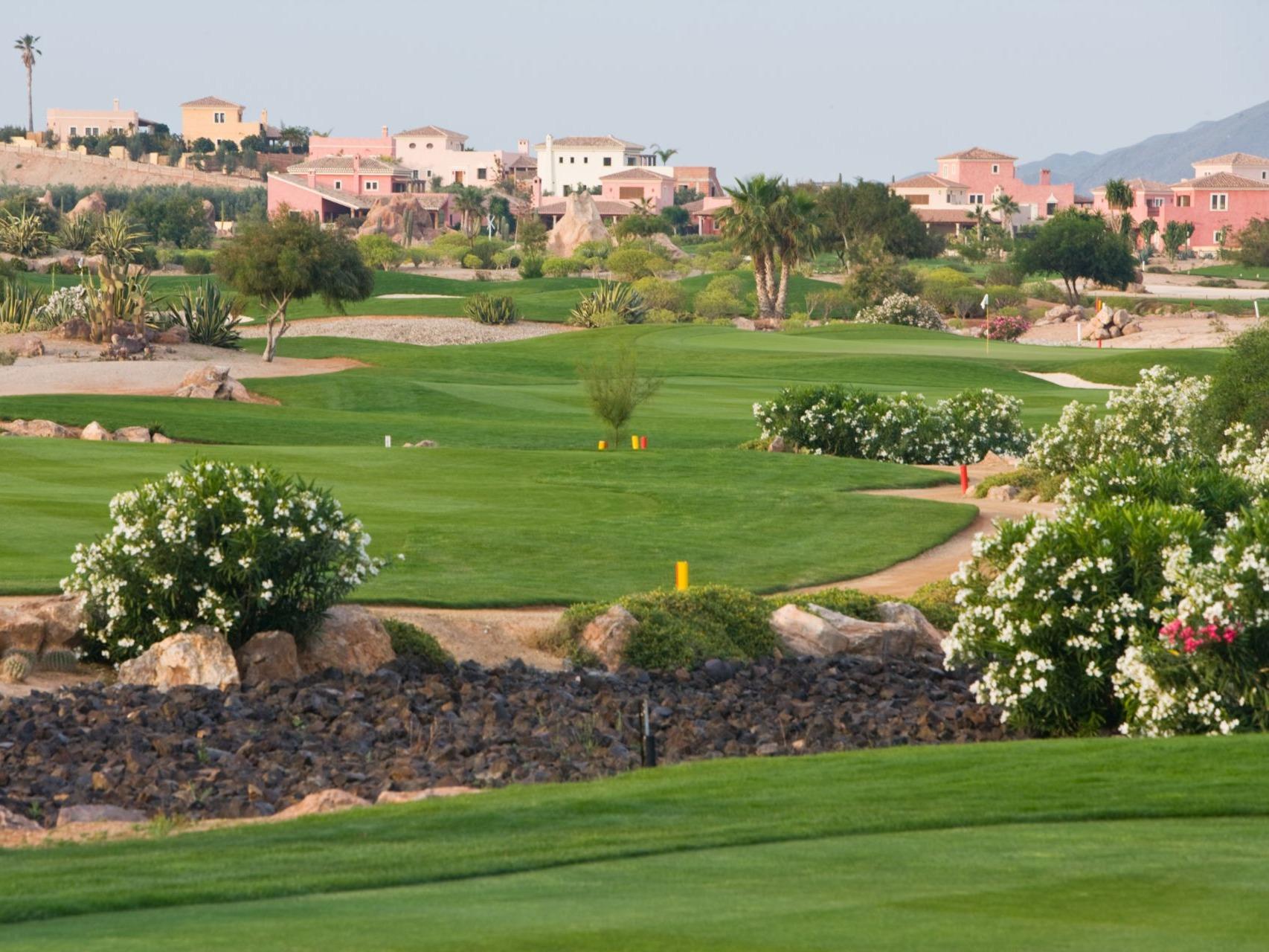 A well maintained fairway nestled with sand bunkers at Desert Springs Resort