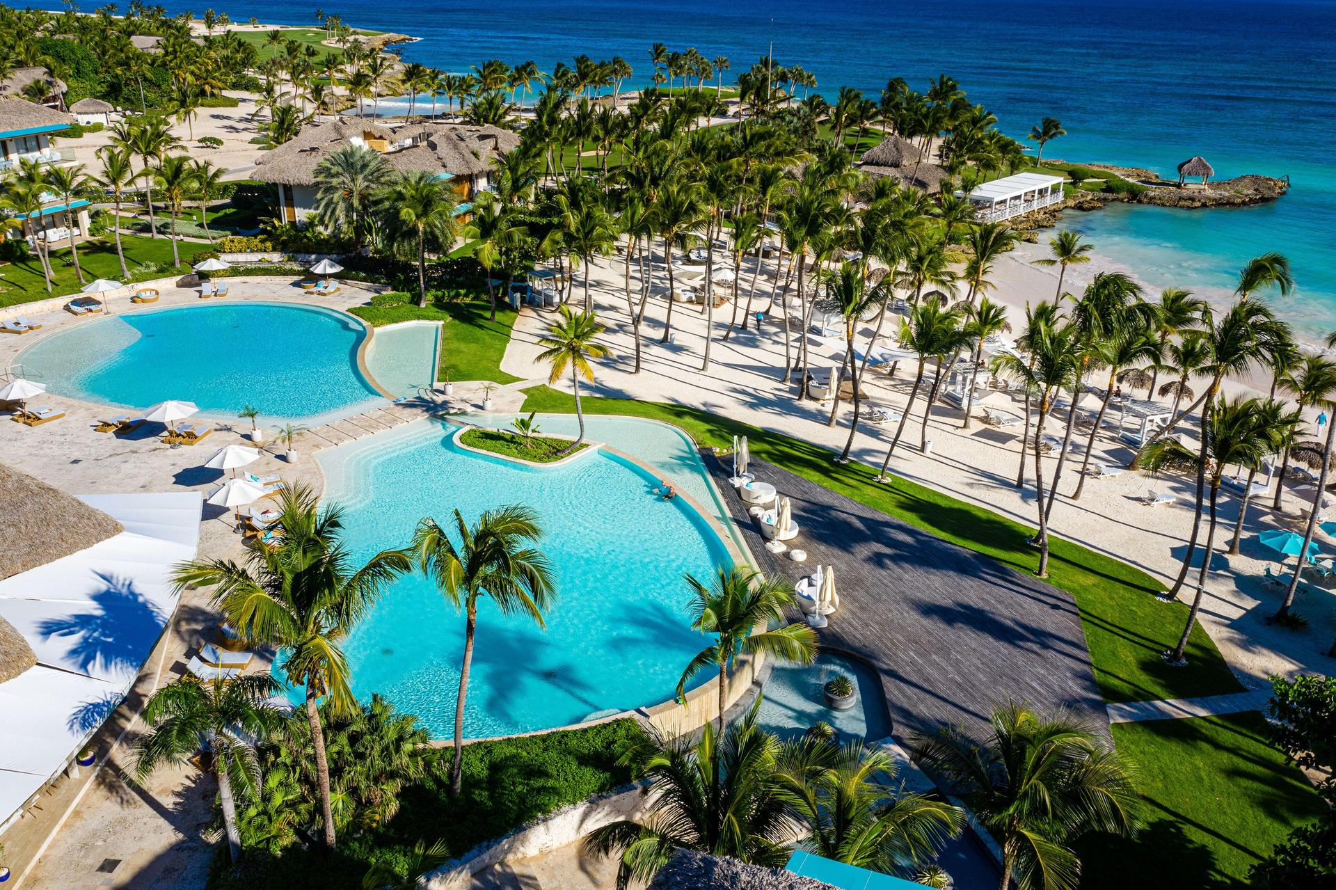 Overhead view of the outdoor pool lined with palm trees at Eden Roc at Cap Cana