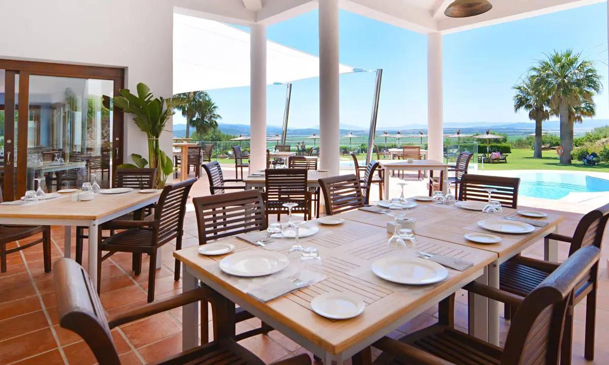 Outdoor poolside dining area at Fairplay Golf & Spa Resort