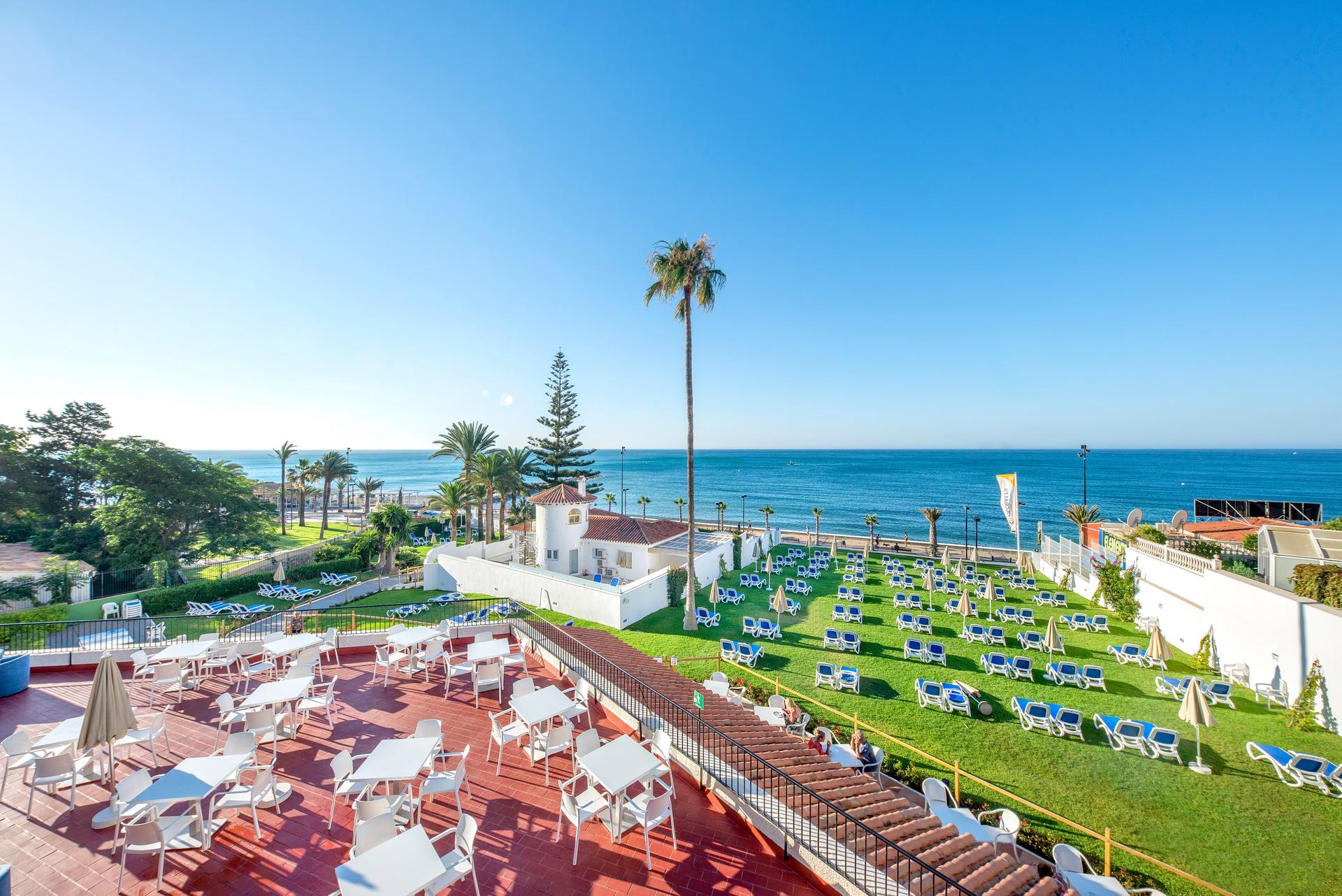 Overhead view of an outdoor lounging area at Globales Gardenia with sea views