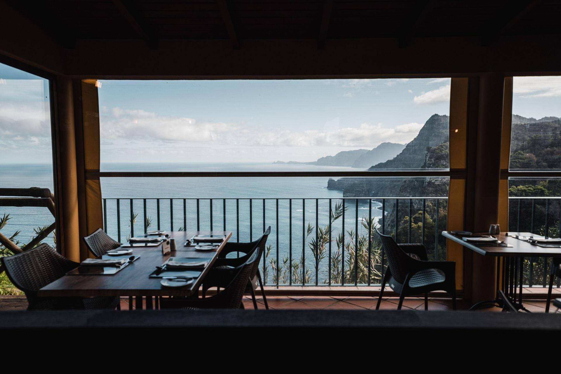 Balcony dining area with ocean views at Hotel Quinta do Furão