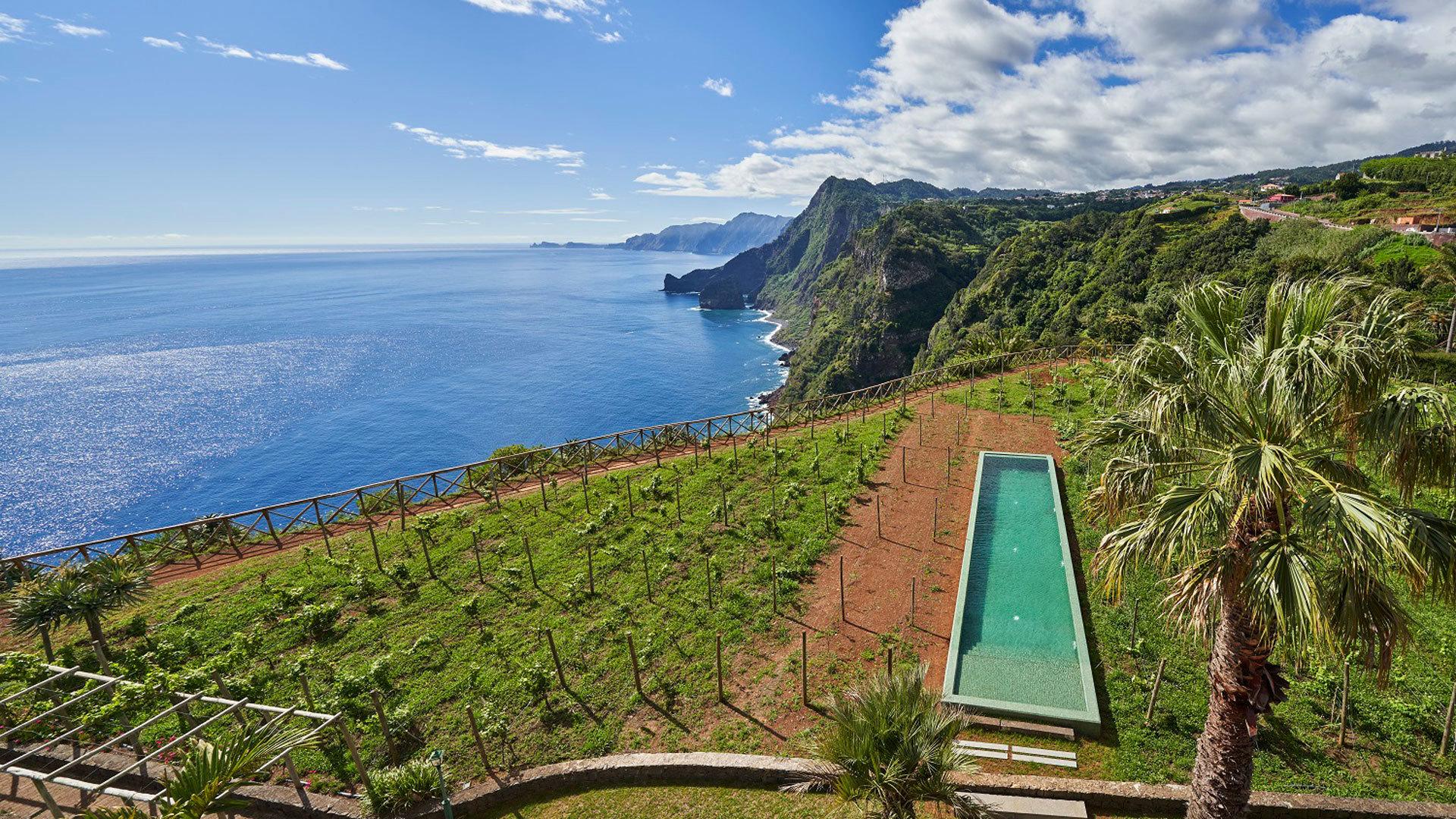 Overhead view of the outdoor pool with ocean views at Hotel Quinta do Furão