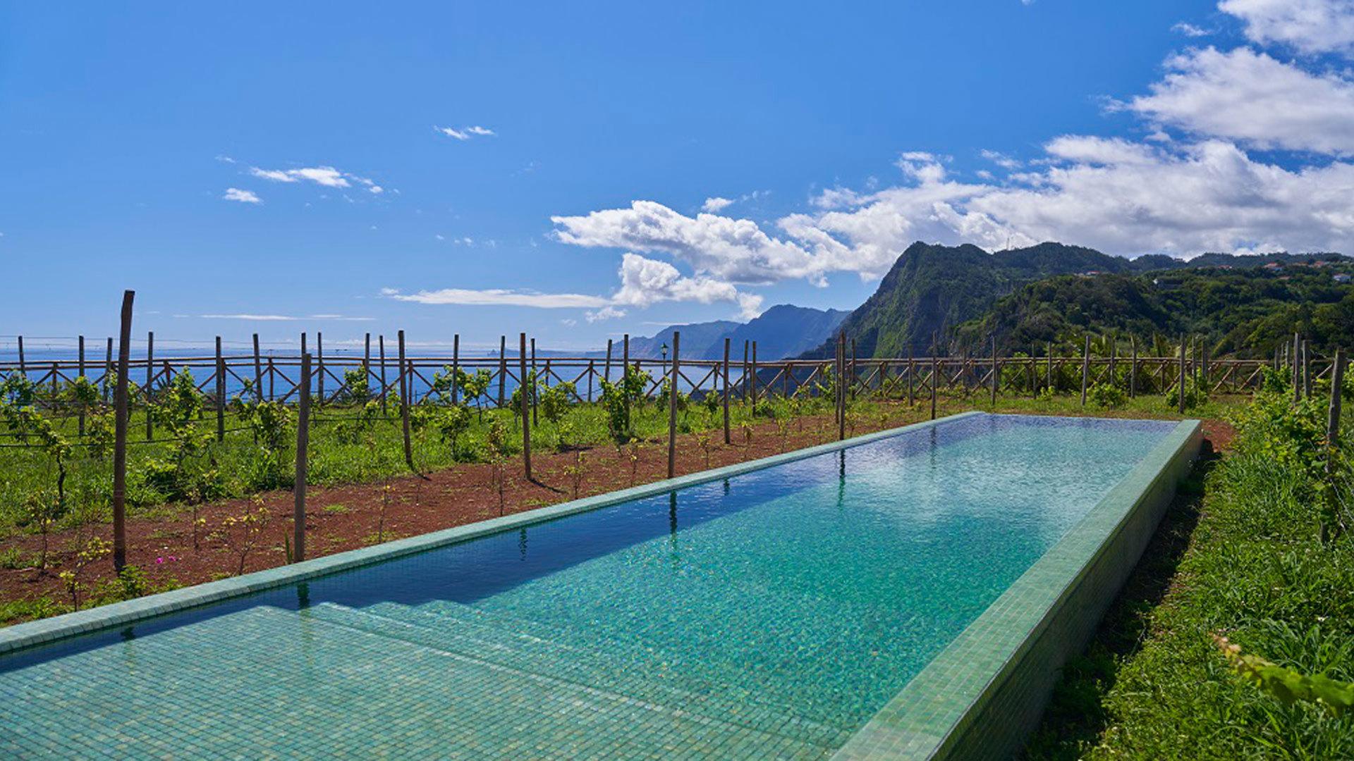 Outdoor pool with ocean views at Hotel Quinta do Furão