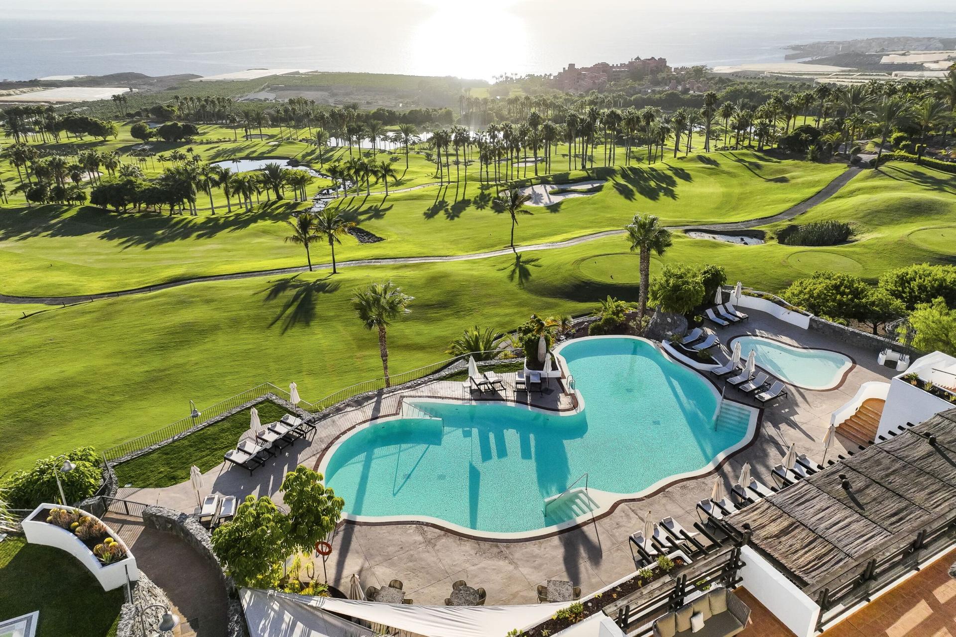 Overhead view of the outdoor swimming pool at Las Terrazas de Abama with views of the golf course