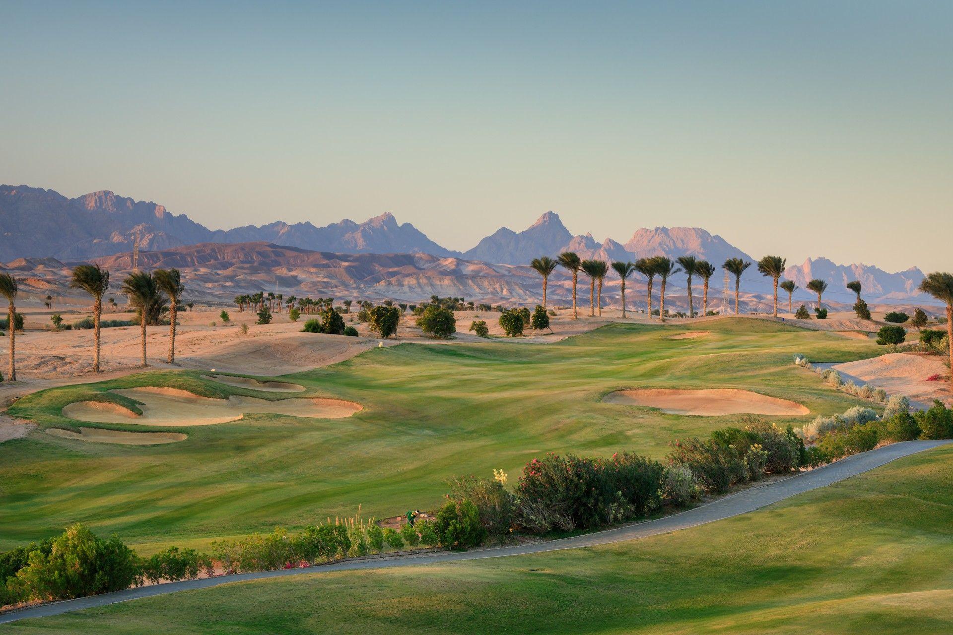 Overhead view of a well maintained fairway littered with sand bunkers