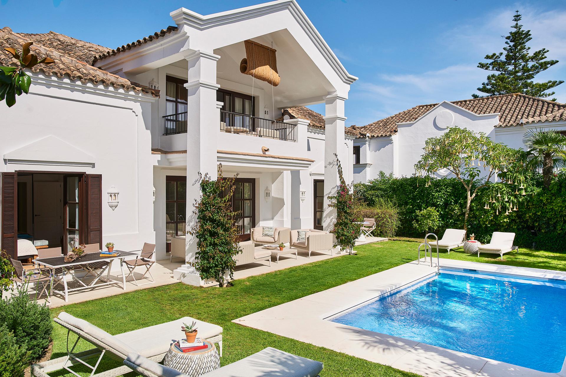 Panoramic view of a villa overlooking an outdoor swimming pool at Marbella Club Hotel