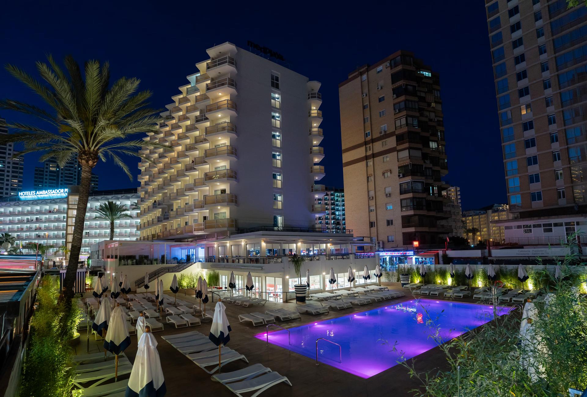 Panoramic view of the Medplaya Hotel Riudor building overlooking the pool at evening