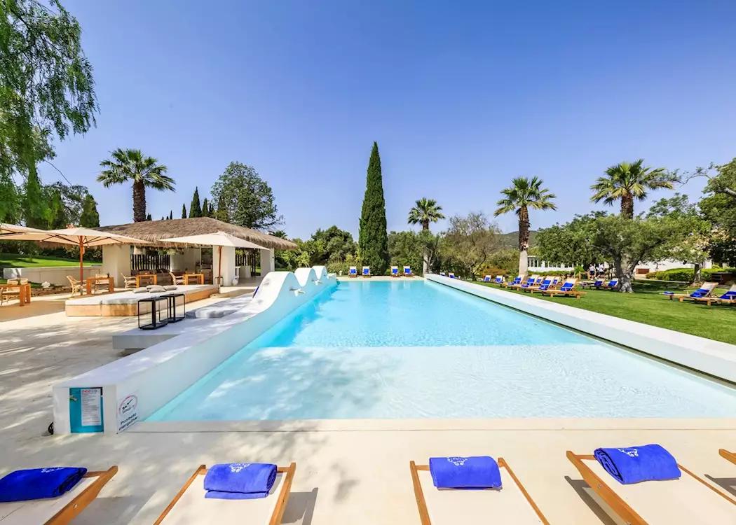Outdoor swimming pool at Octant Hotel Vila Monte lined sun beds