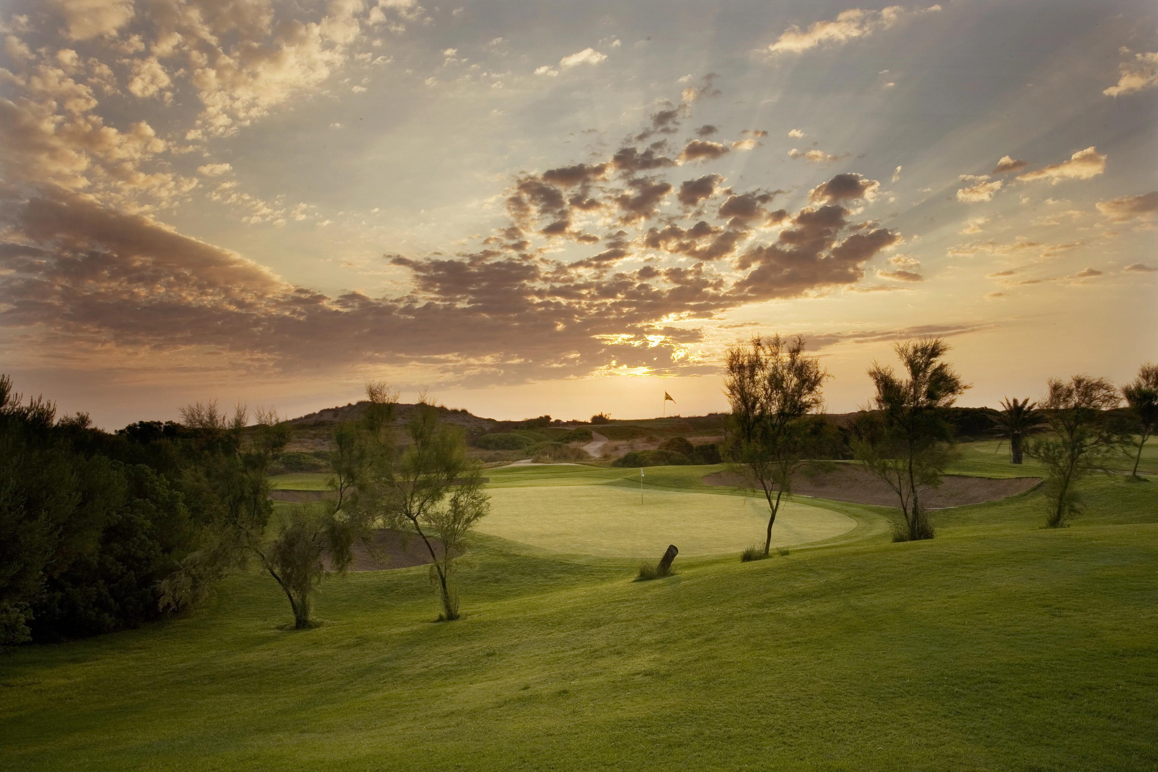 A well maintained fairway leading to a smooth green at Parador El Saler