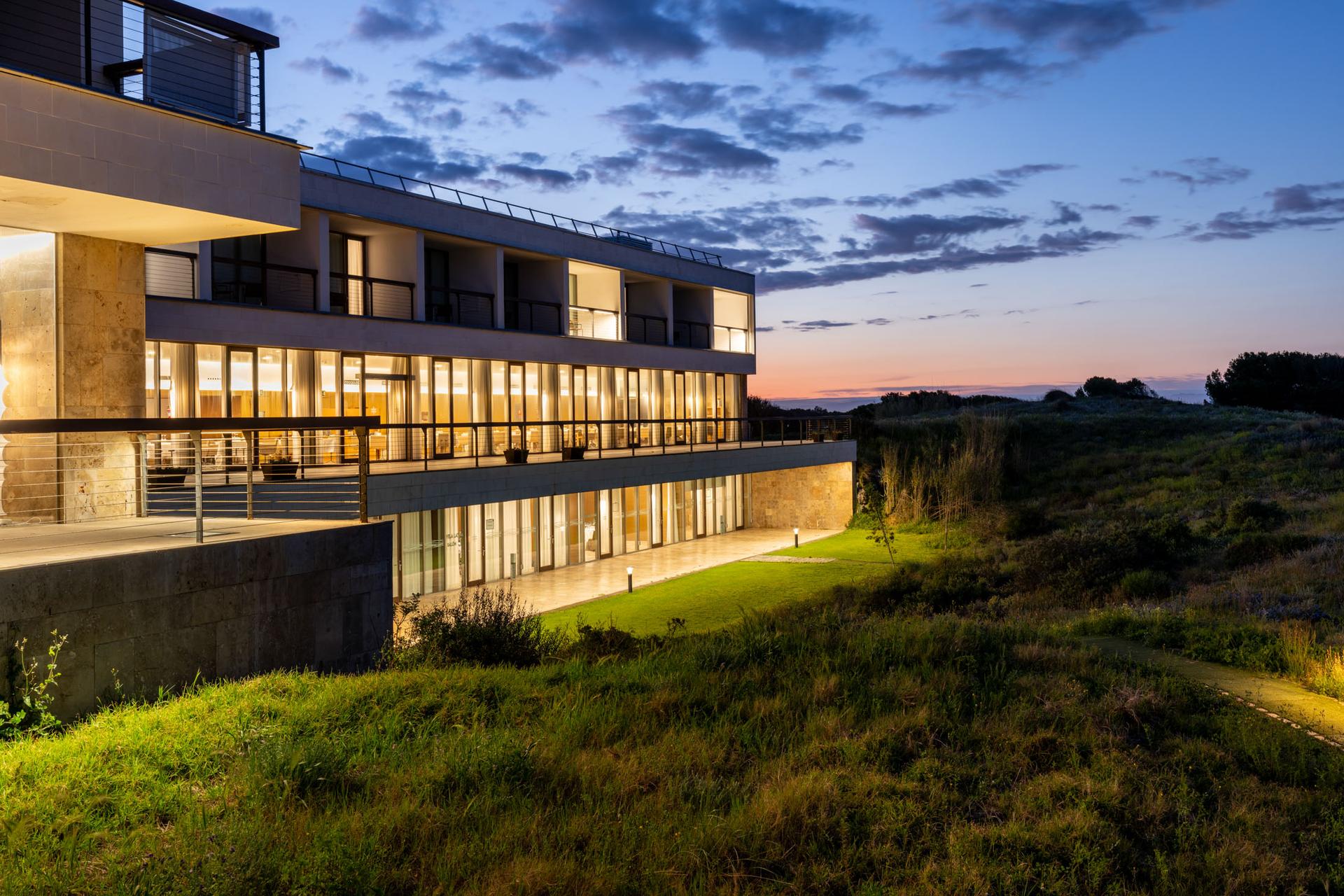 The Parador El Saler building lit up at night