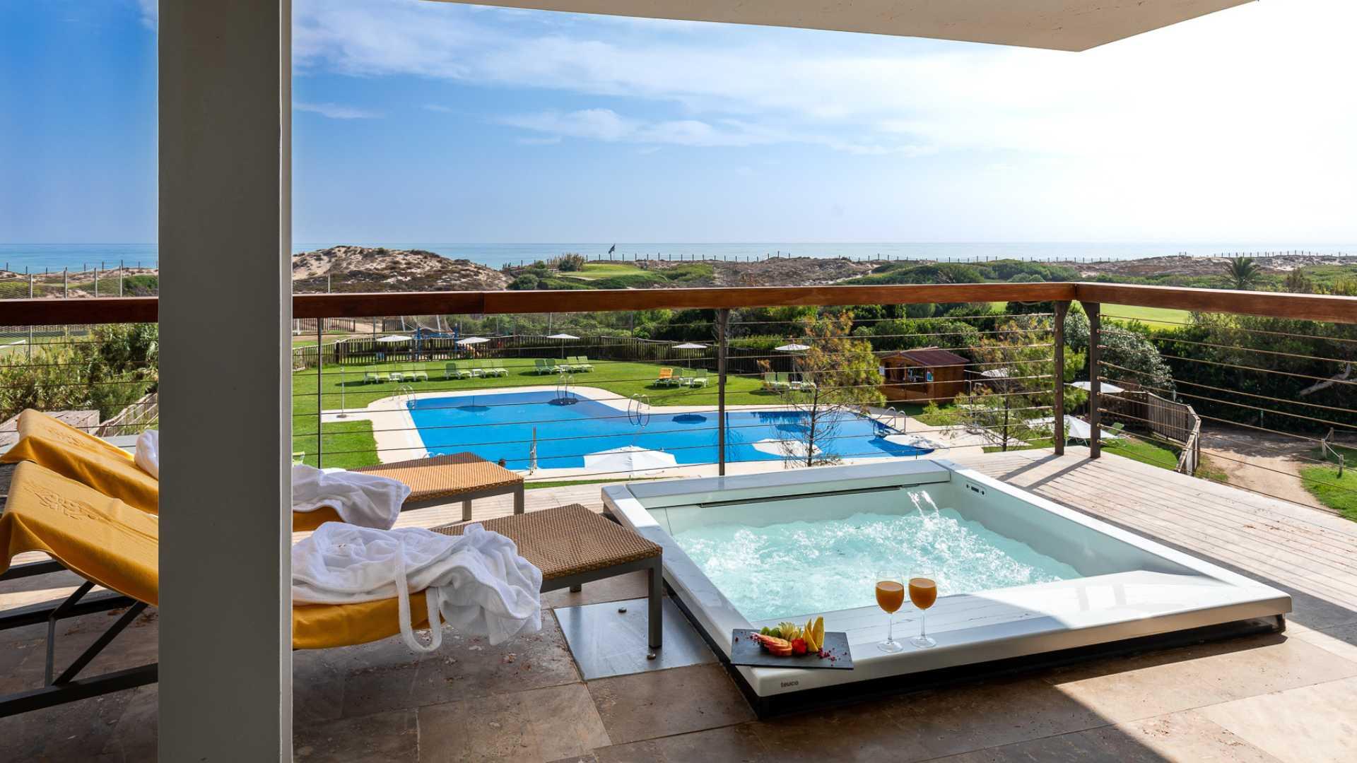 Balcony nestled with a jacuzzi and views of the outdoor pool
