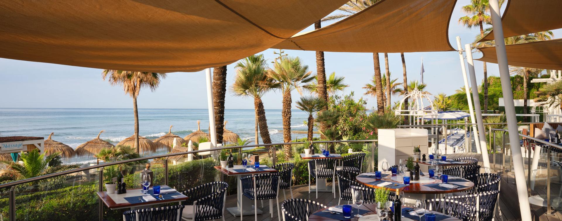 Outdoor dining with ocean views at Puente Romano Beach Resort