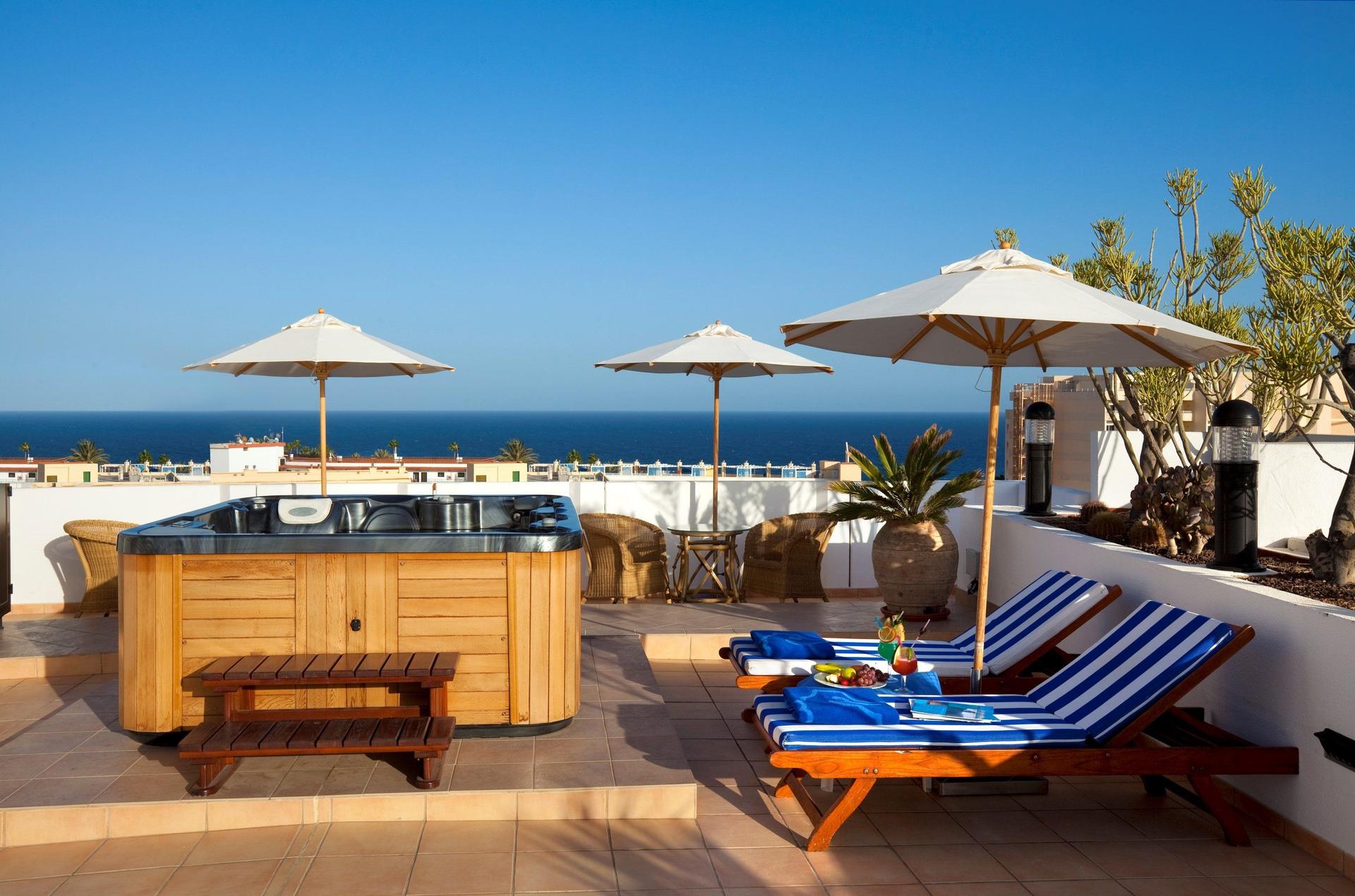 Rooftop sunbeds and jacuzzi at Seaside Sandy Beach