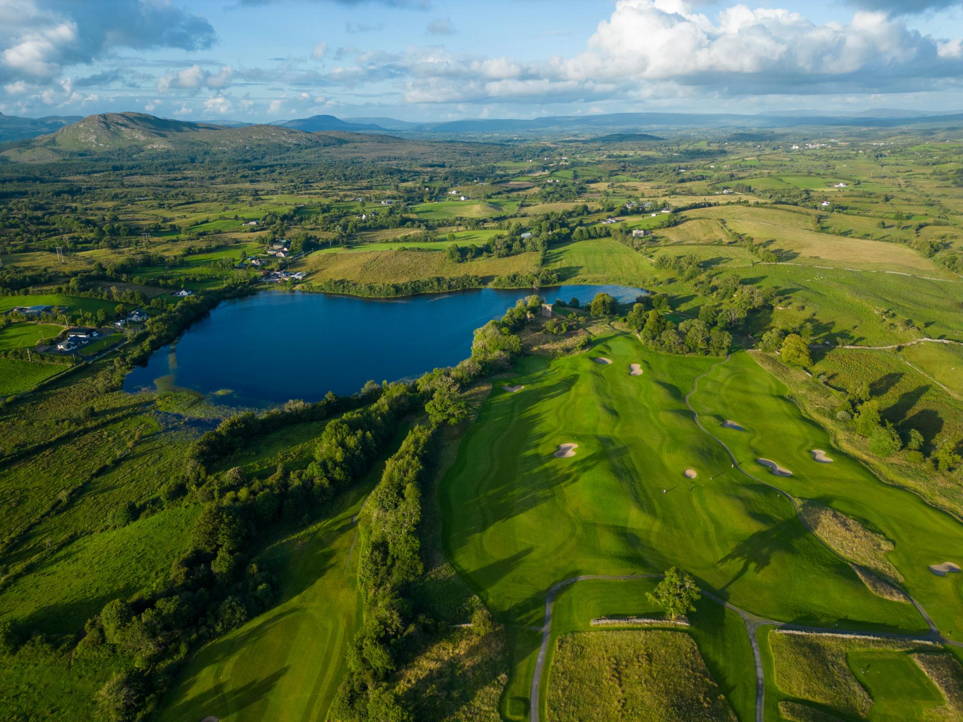 Aerial view of a well maintained fairway nestled with sand bunkers