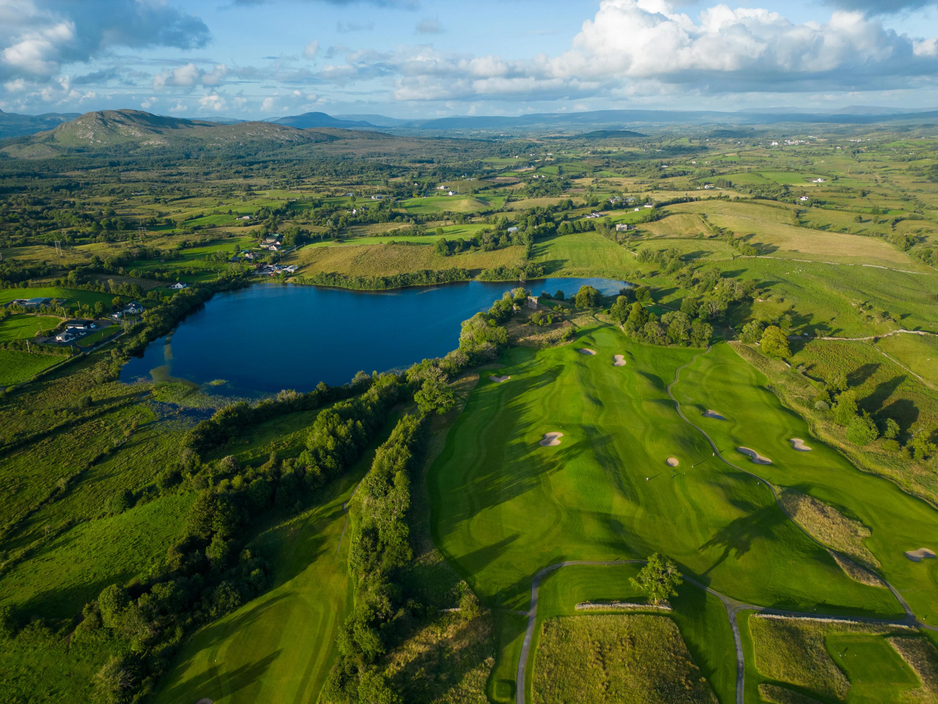 Aerial view of a well maintained fairway nestled with sand bunkers