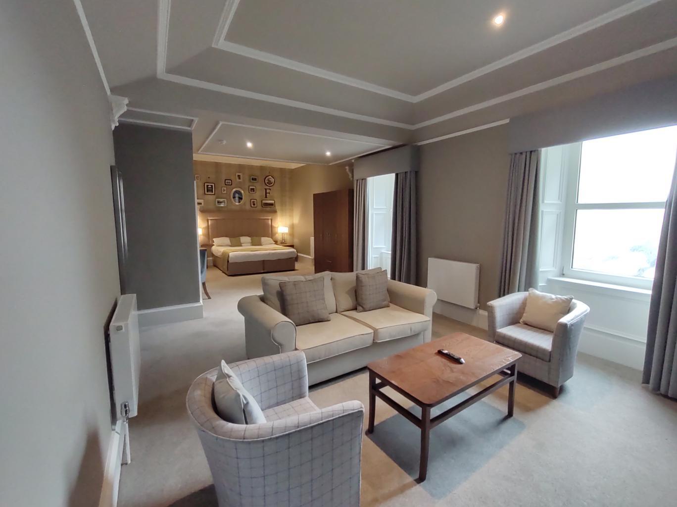 Spacious double bed suite with a lounging area at Fairfield House Hotel