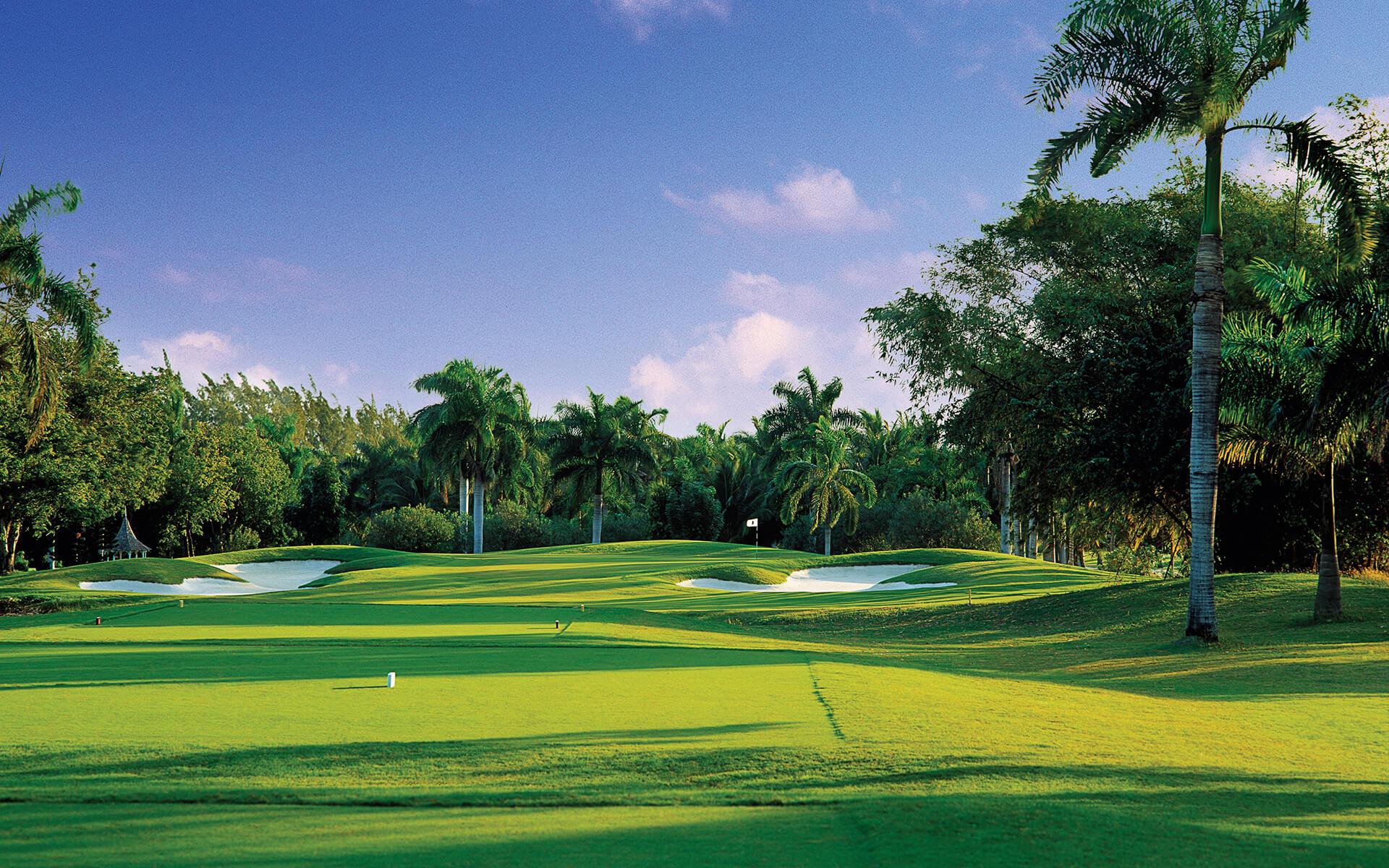 A well maintained fairway nestled with sand bunkers