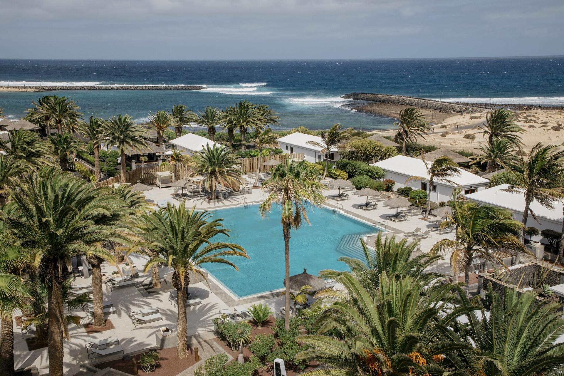 Overhead view of the outdoor pool with distant sea views at Paradisus Salinas Lanzarote